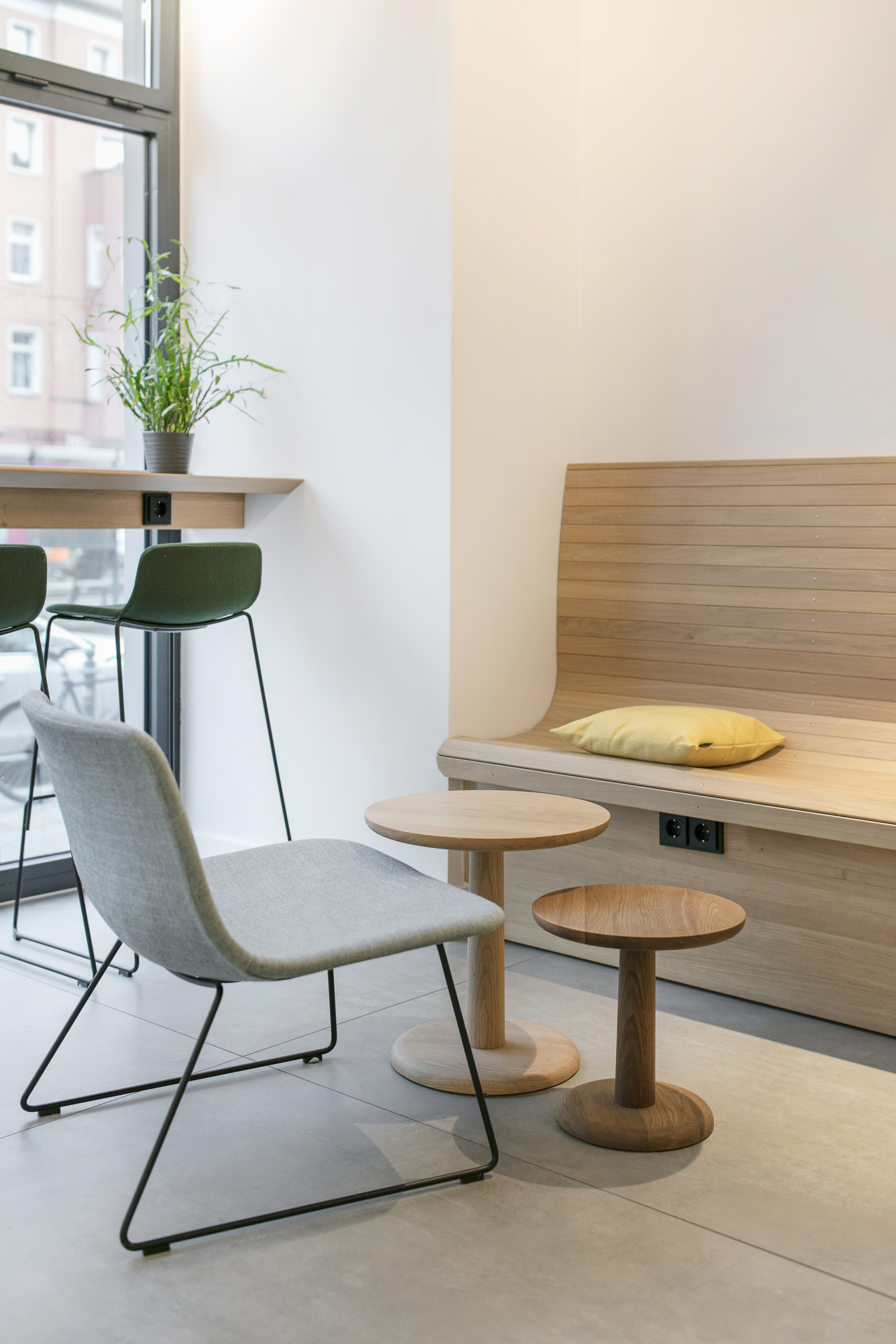 High-quality, bright tiles in a modern room with wooden benches and designer furniture.