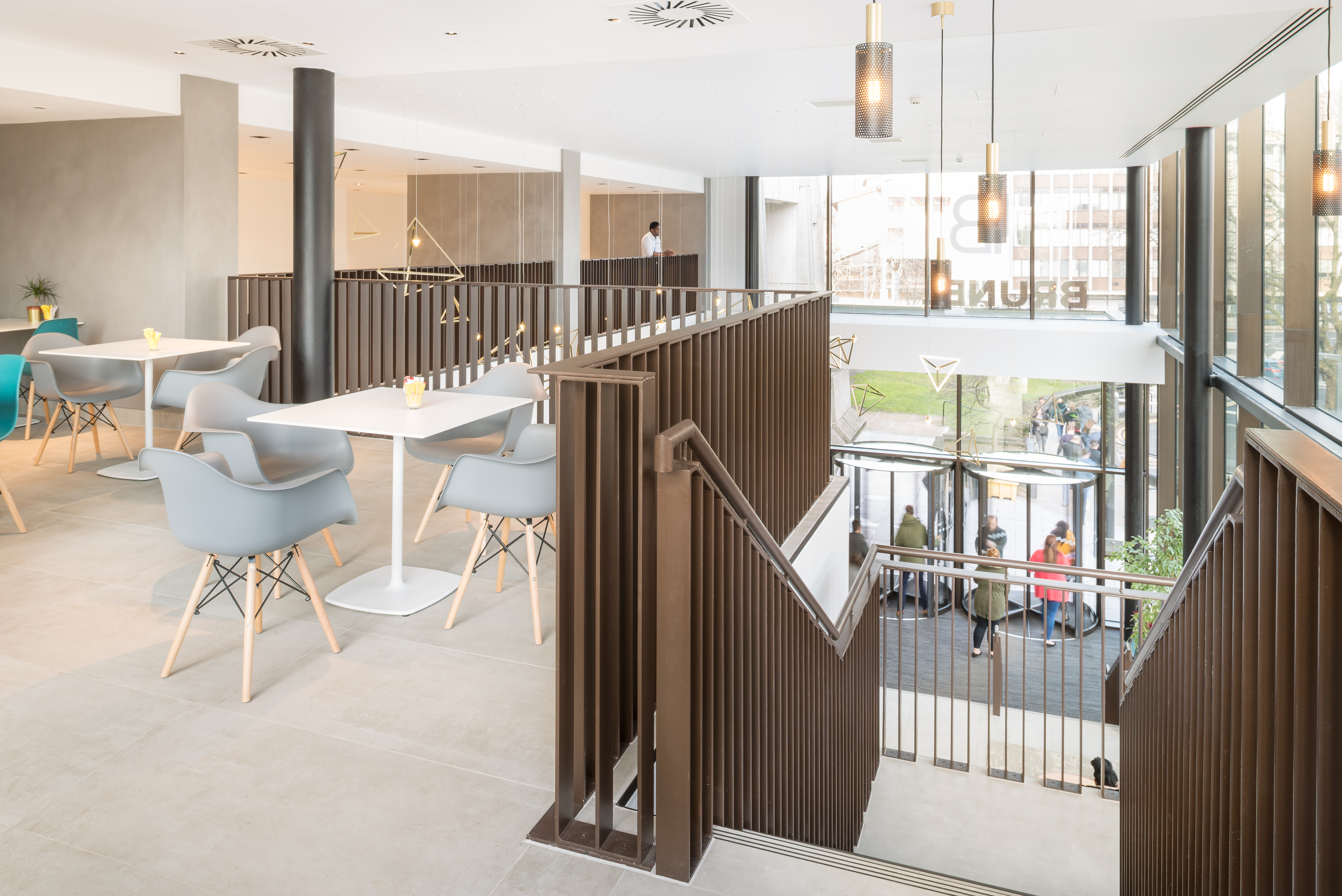 Bright, large-format tiles in a modern, open lounge area.