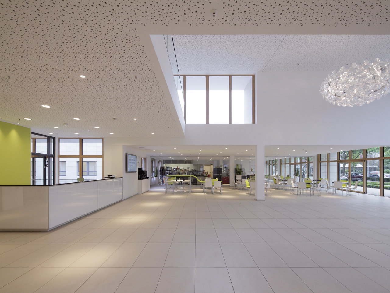Light, large-format floor tiles in an elegant, modern foyer with reception.