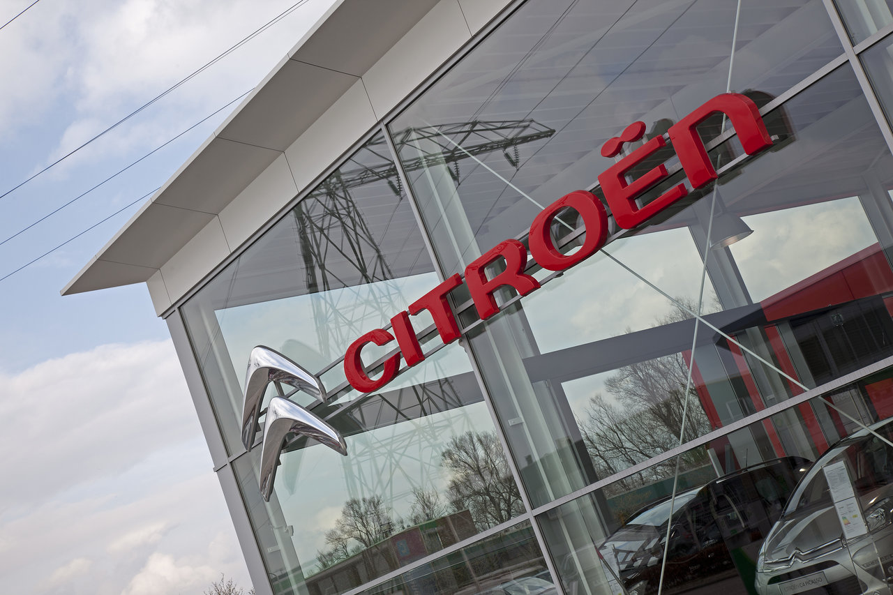Citroën Logo and Emblem on a car dealership's glass facade.