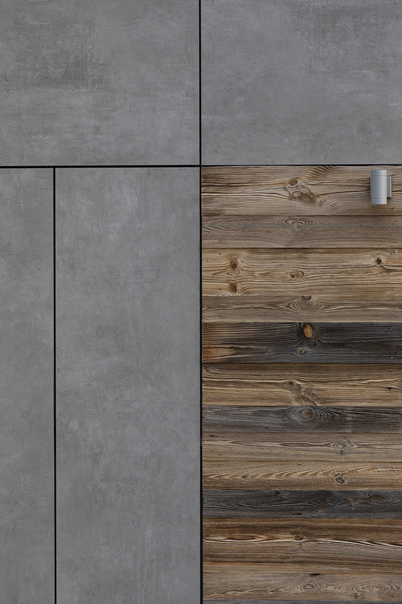 Large grey concrete-look tiles and rustic wood-look panels.