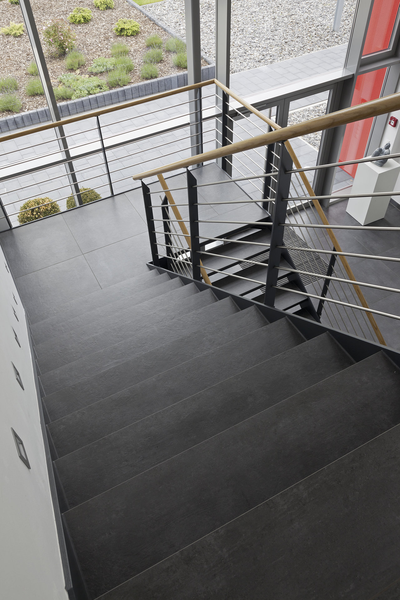 High-quality dark grey tiles on modern indoor staircase.
