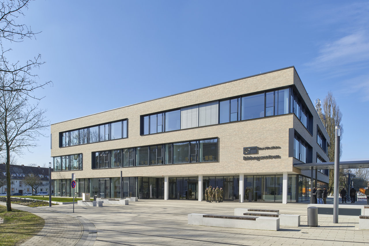 Modern building with bright facade and spacious plaza, ideal for premium tiles.