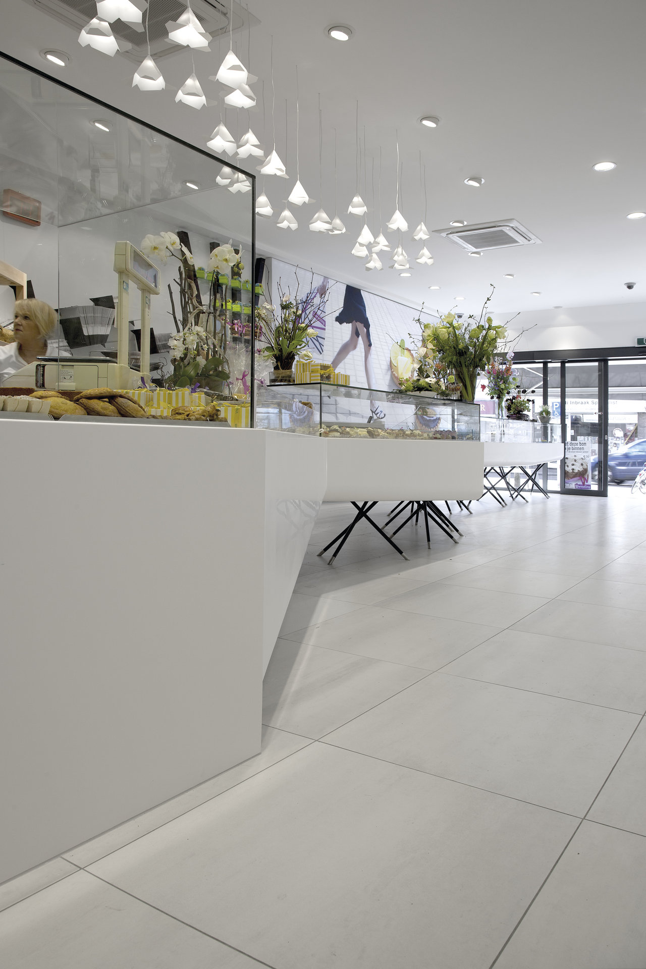 Light, large-format porcelain floor tiles in a modern store.
