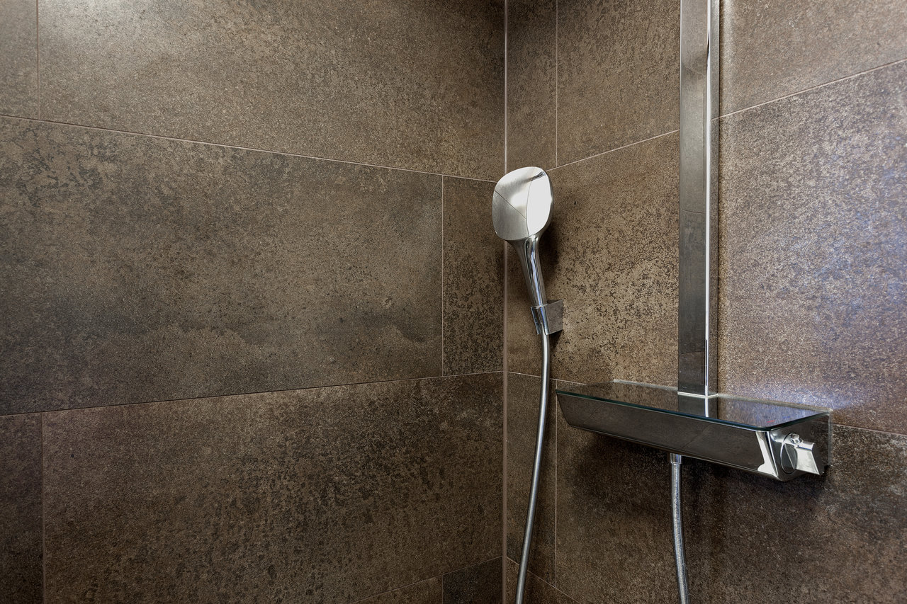 Dark brown natural stone effect tiles for bathroom & shower.
