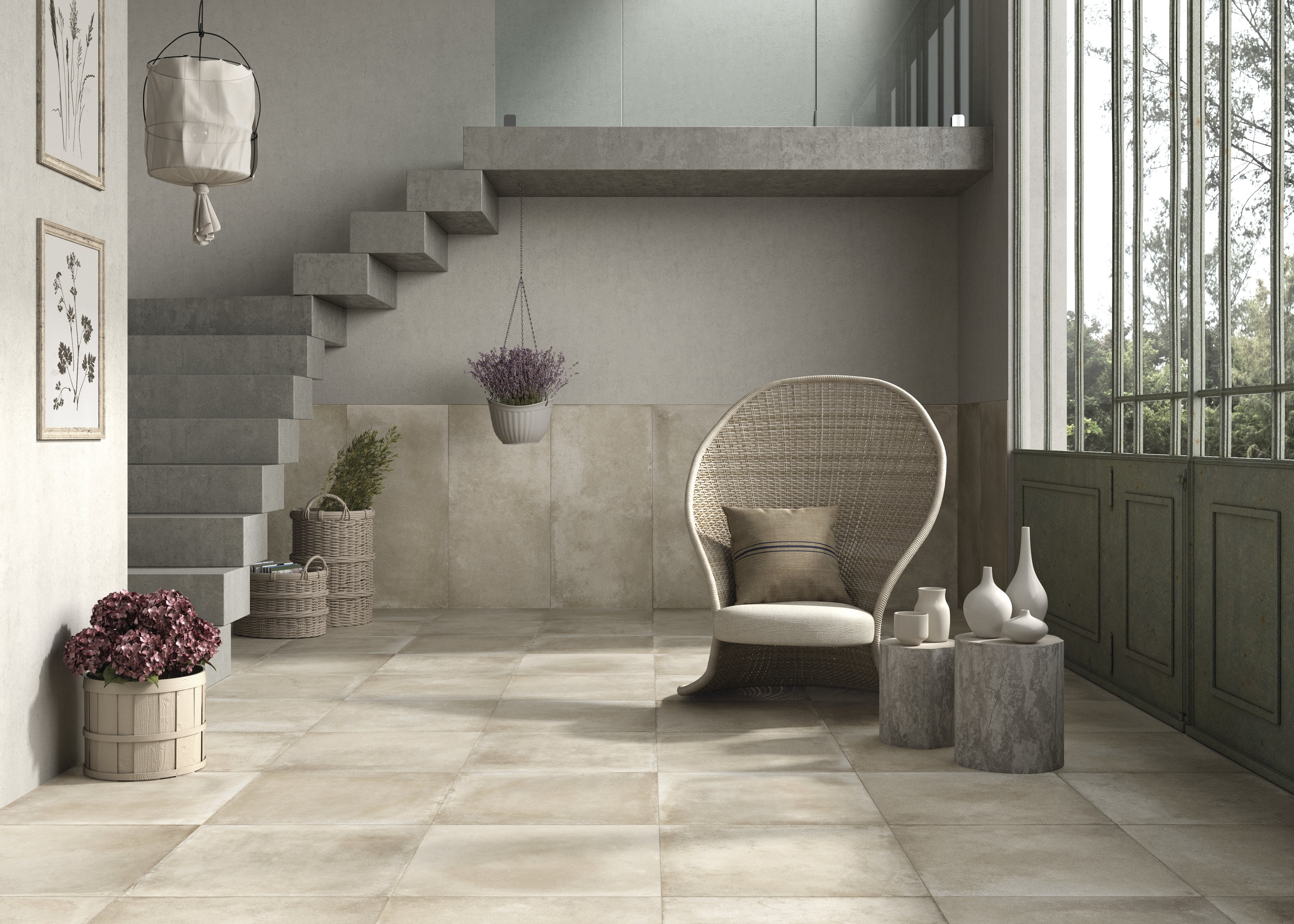 Bright, large-format tiles in a modern living room with stairs, an armchair, and plenty of light.