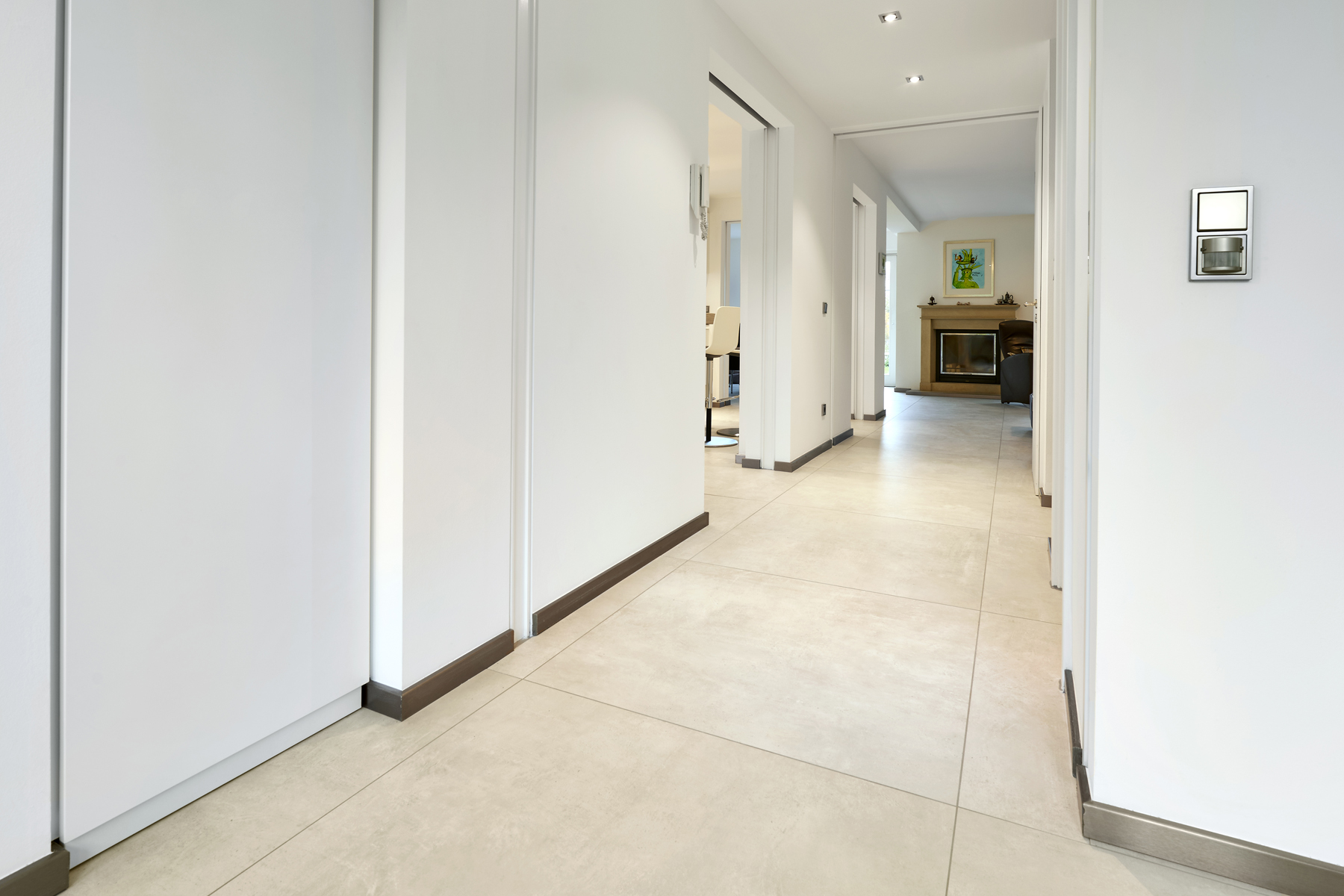 High-quality, light tiles in a modern hallway.