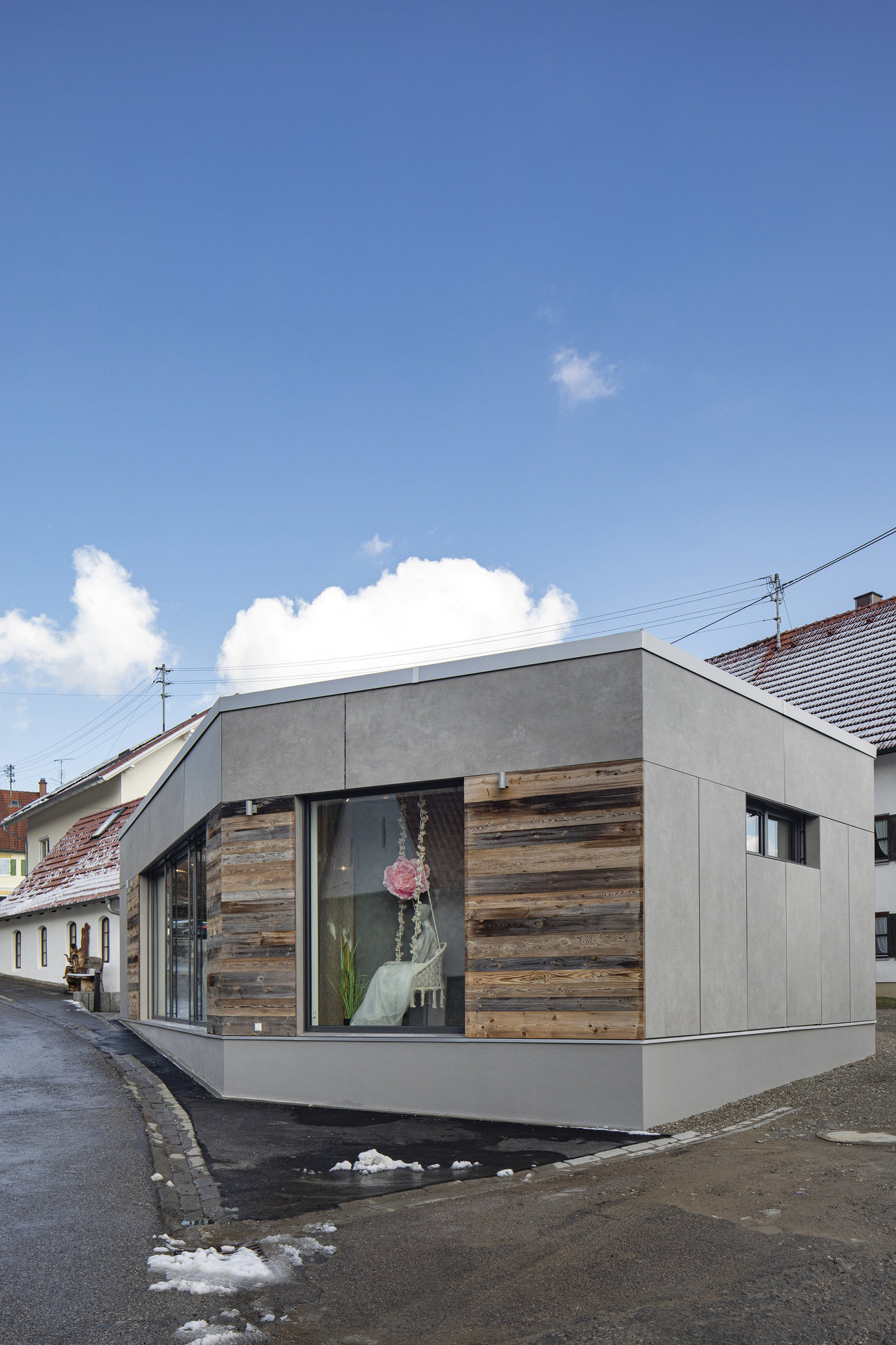 Modern building with concrete and wood facade, offering design inspiration for tiles.