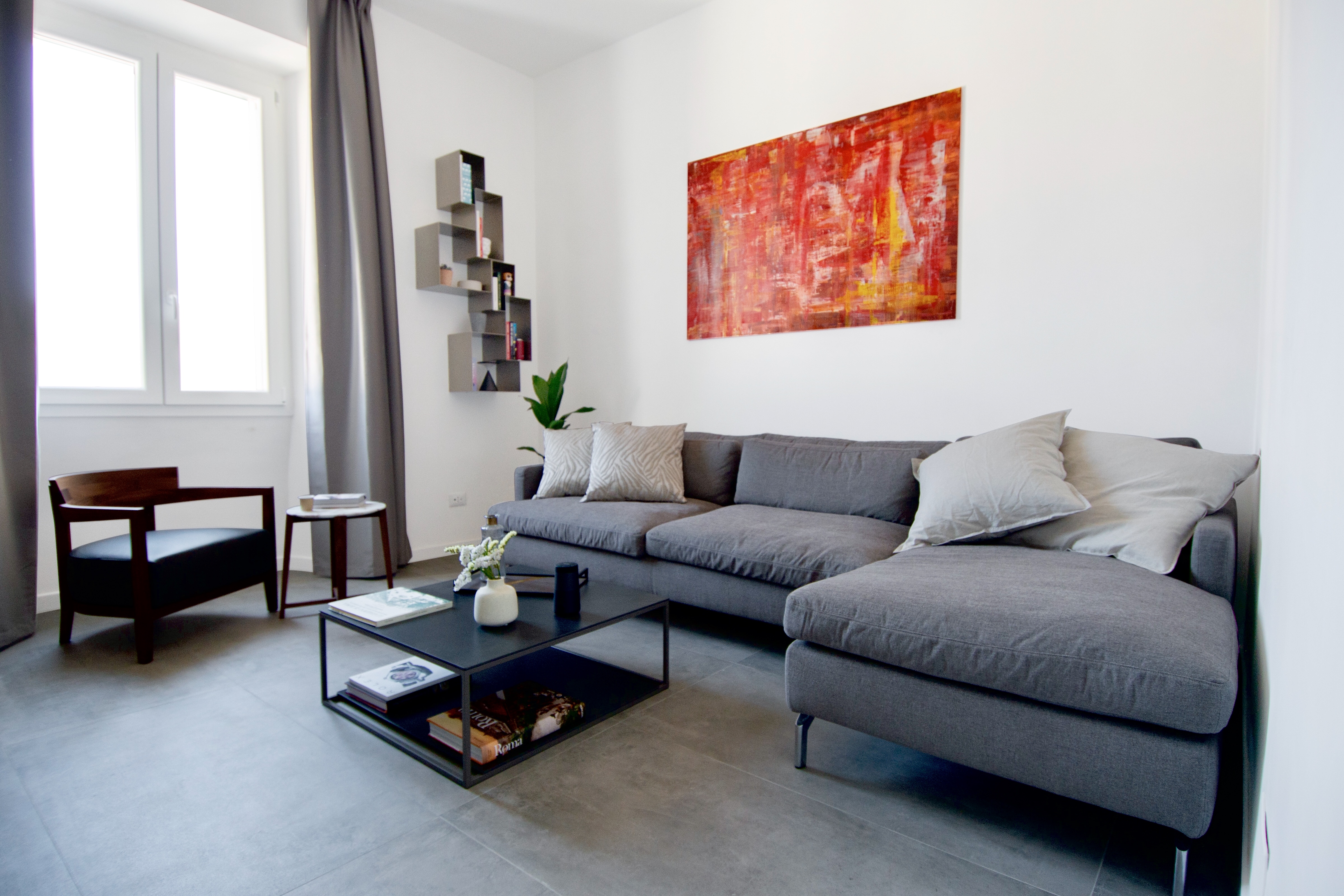 Contemporary living room with high-quality grey floor tiles.