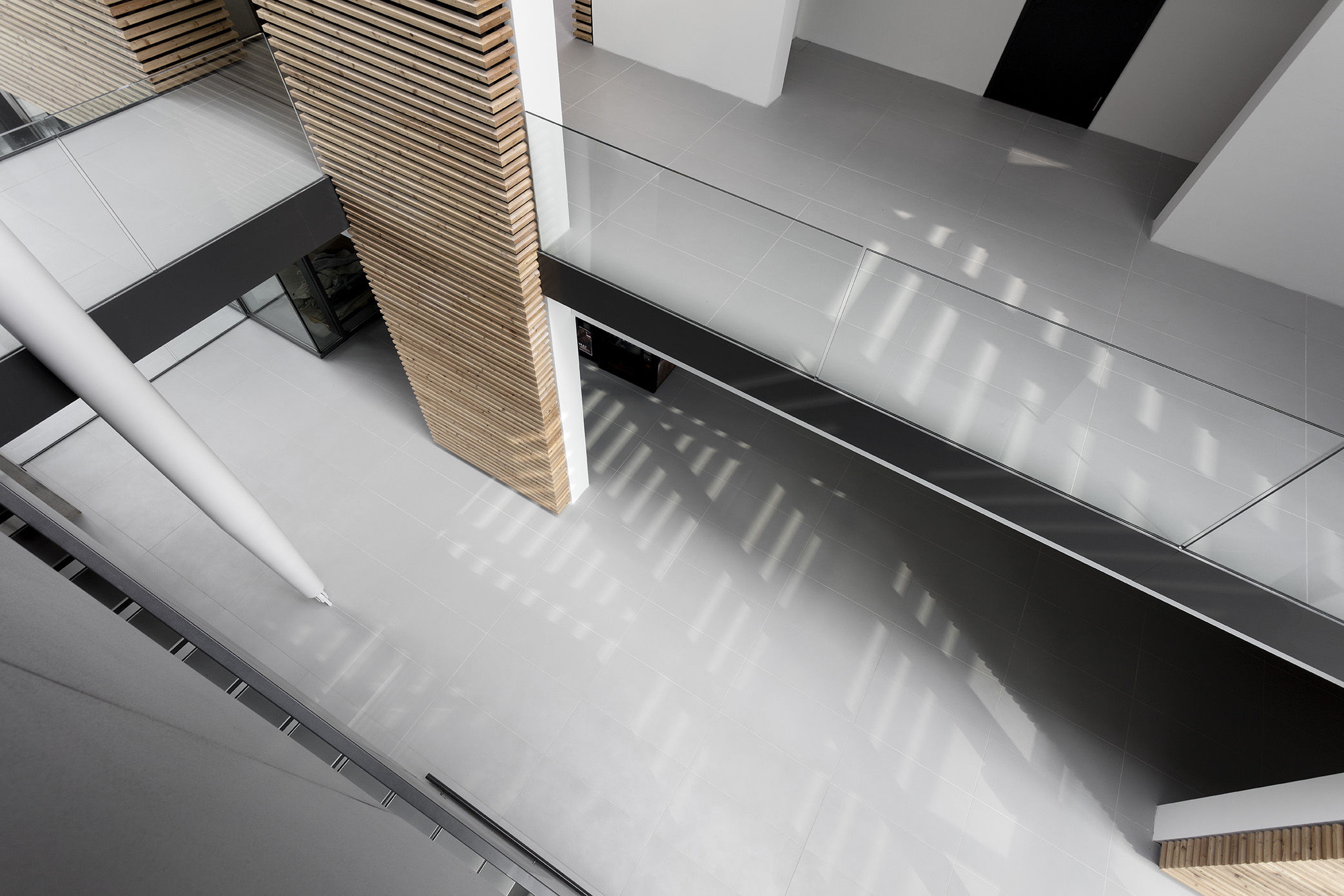 Bright, modern architecture with large-format grey floor tiles.