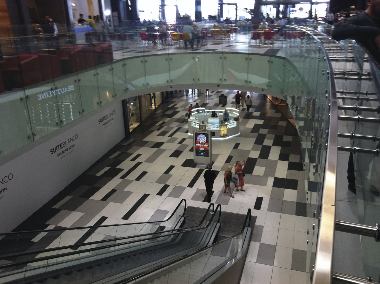 Tiled floor with modern, graphic pattern in Black, Grey and White.