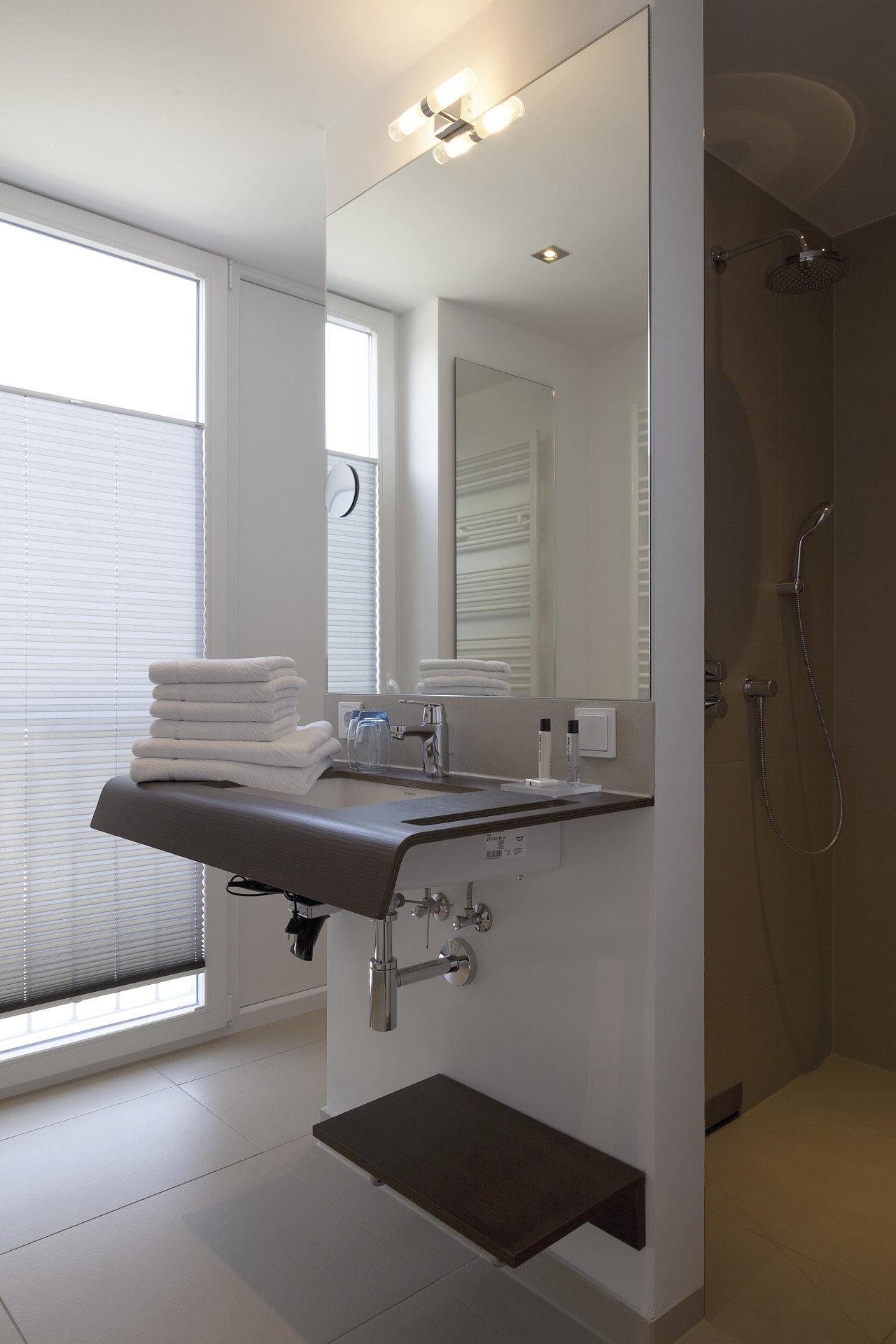 High-quality tiles in a modern bathroom with a floating vanity.