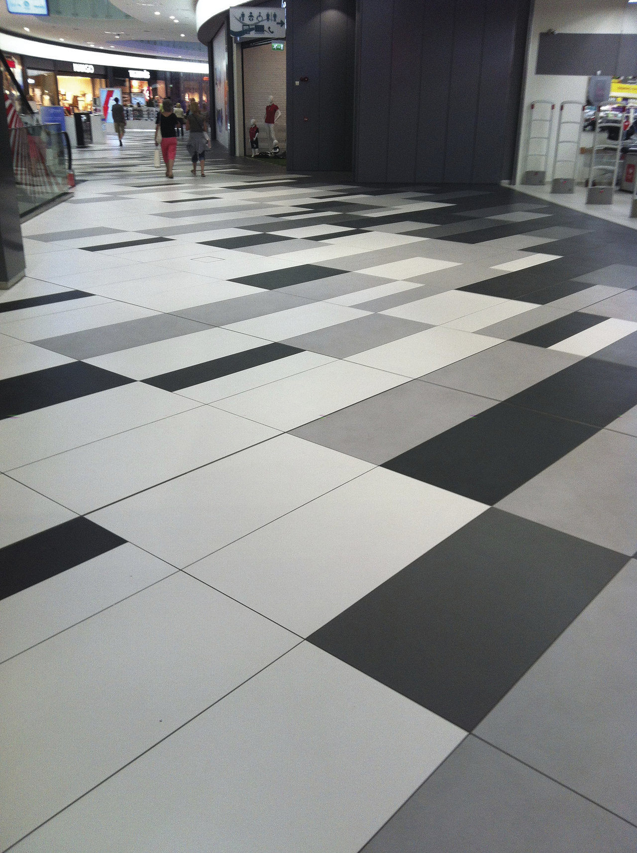 Designer tiles in black, white, and grey with a modern geometric pattern.