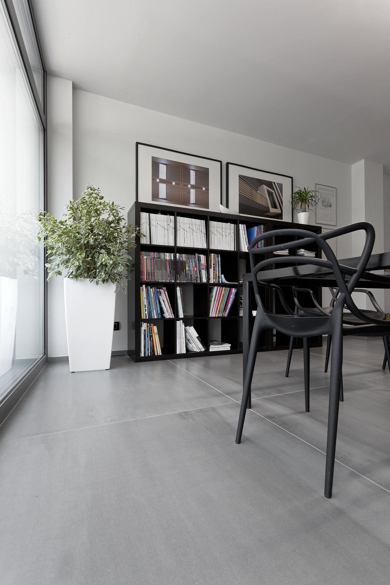 Large, light grey concrete-effect tiles in a modern living-dining area.