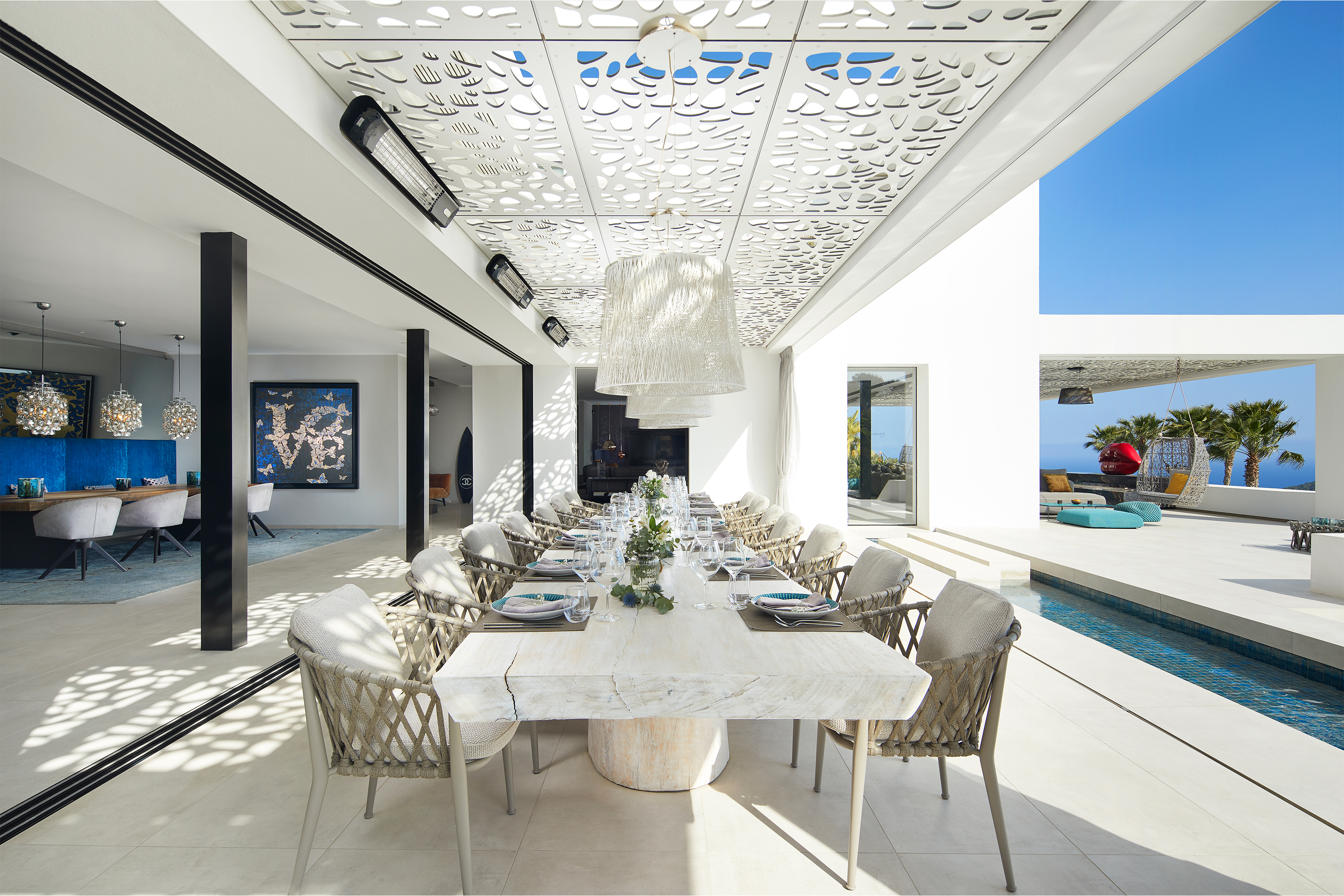 Modern dining area with high-quality tiles, open design, and pool access.
