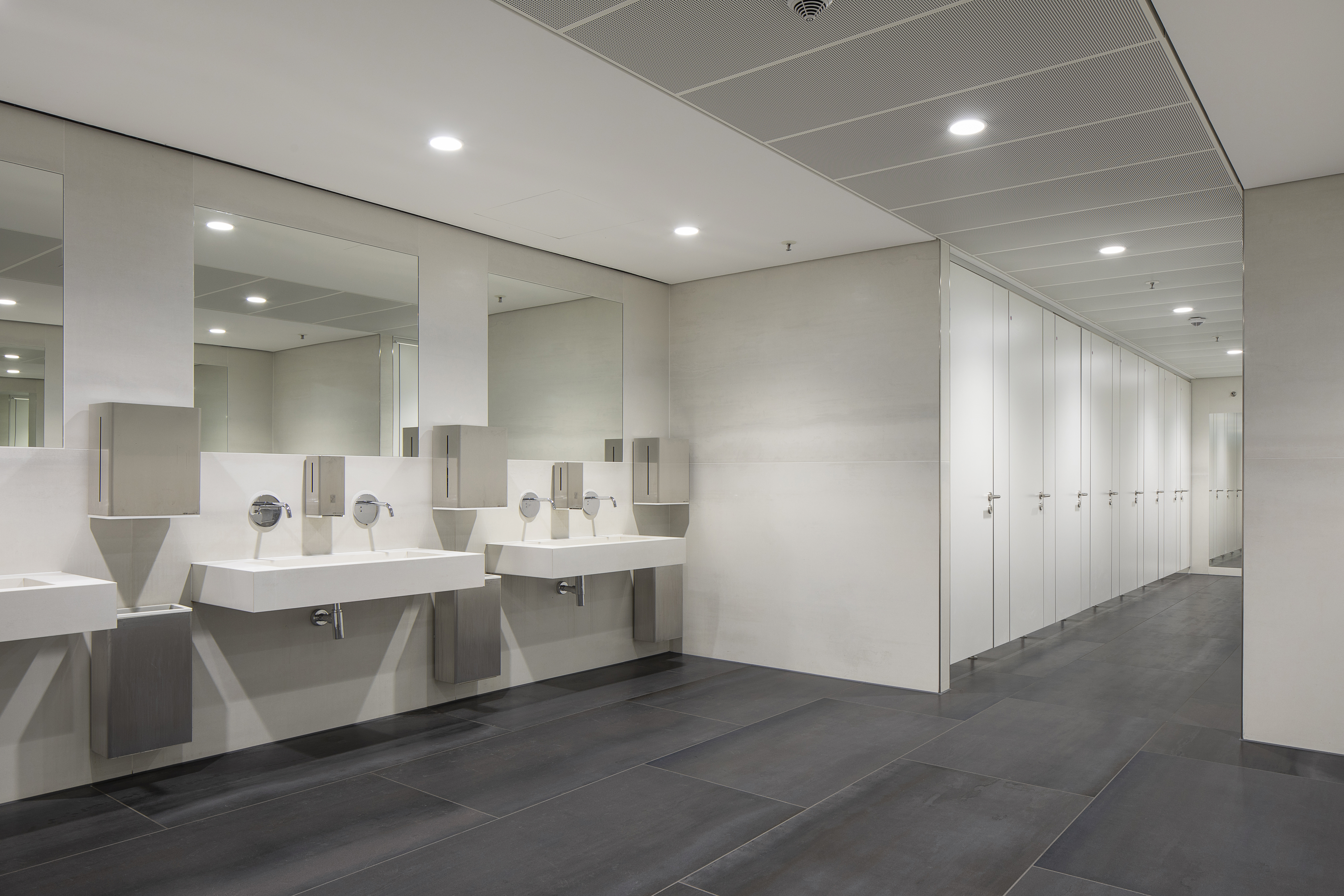 Premium dark floor tiles in a modern bathroom.