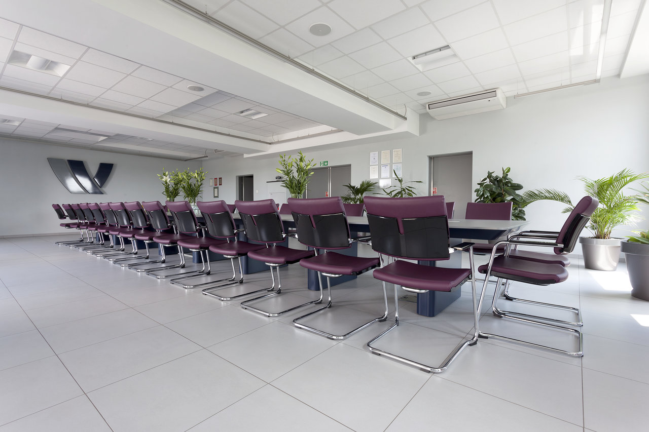 Bright conference room with high-quality, large-format floor tiles.