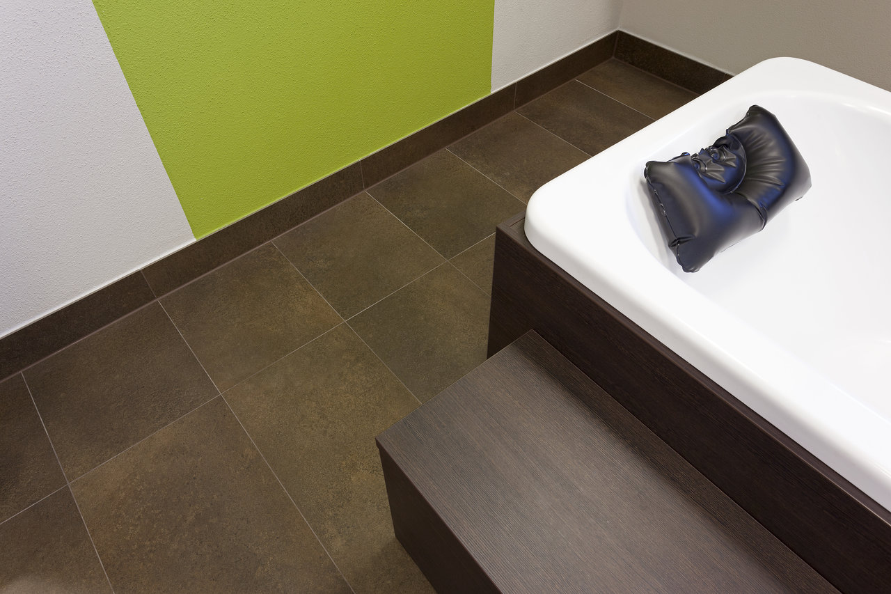 Modern dark, matte floor tiles, ideal for bathrooms and living areas.