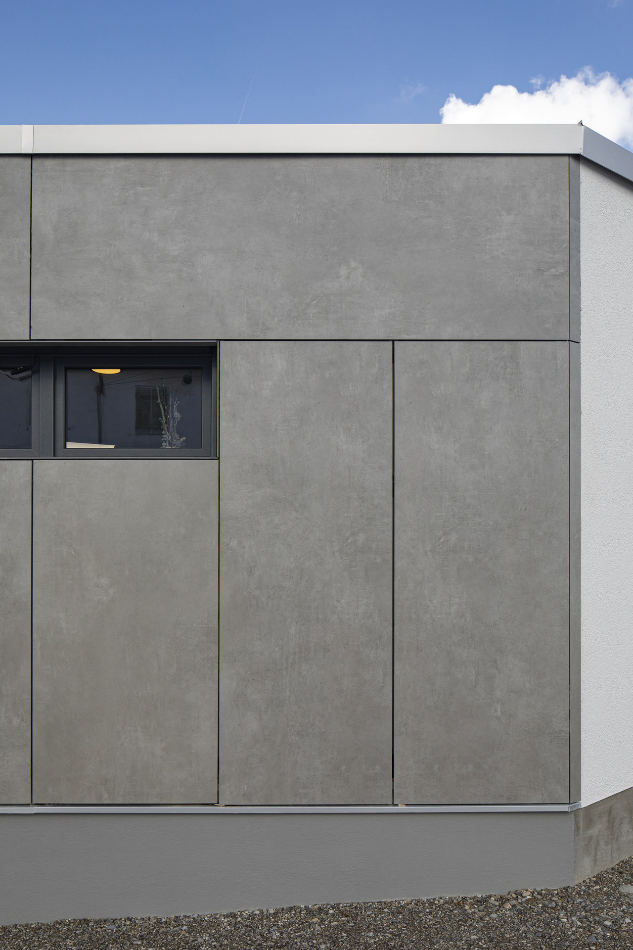 Grey outdoor tiles as modern facade cladding.