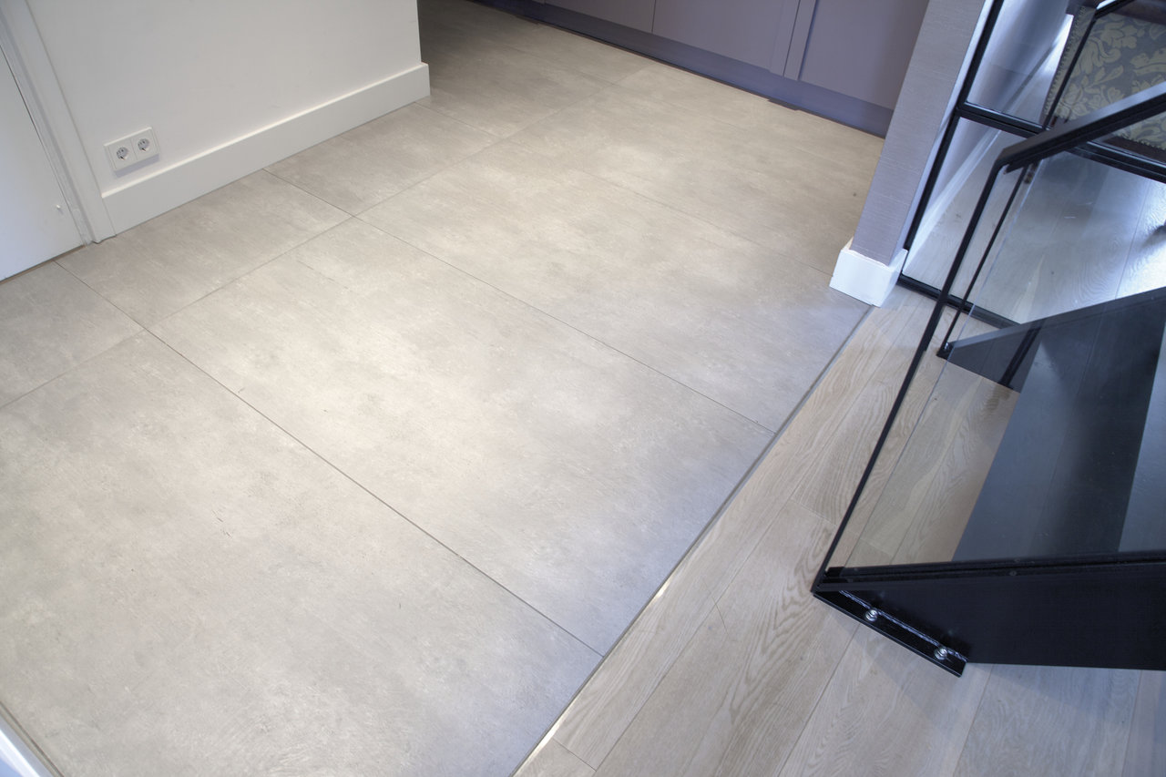 High-quality, light grey indoor tiles with a concrete look.