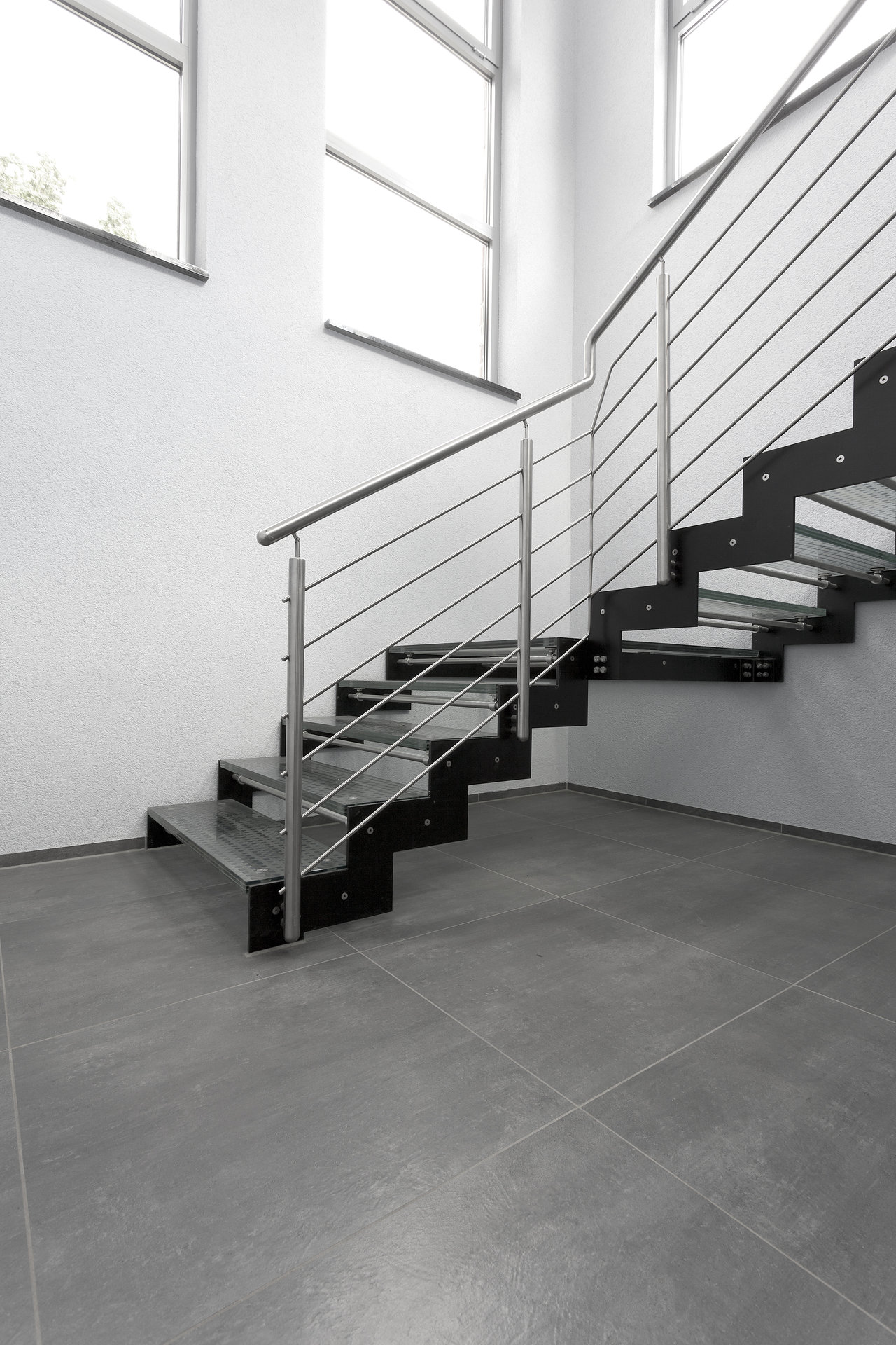Large-format grey tiles in a modern staircase.