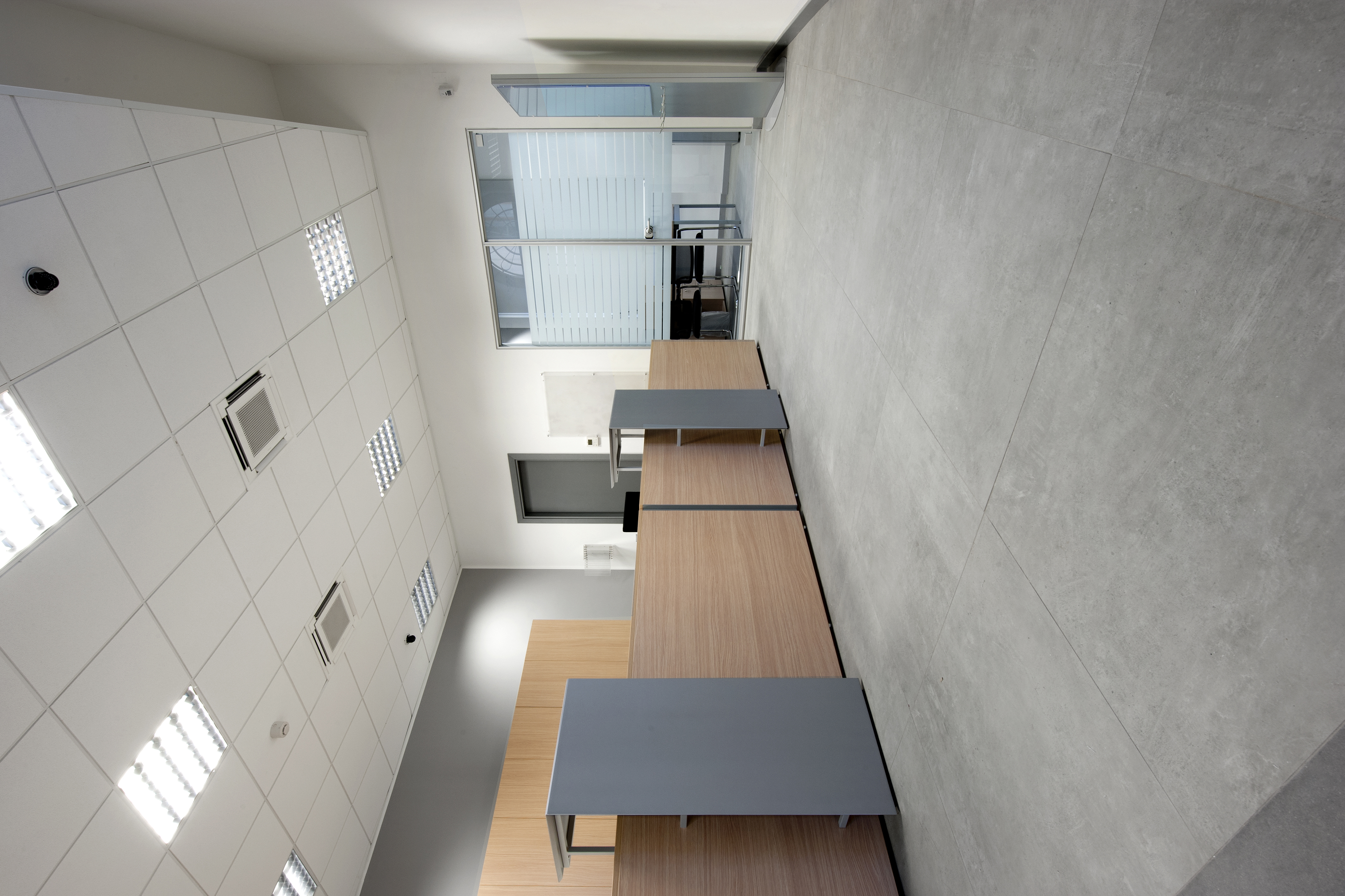 Bright, modern room with large-format grey floor tiles.