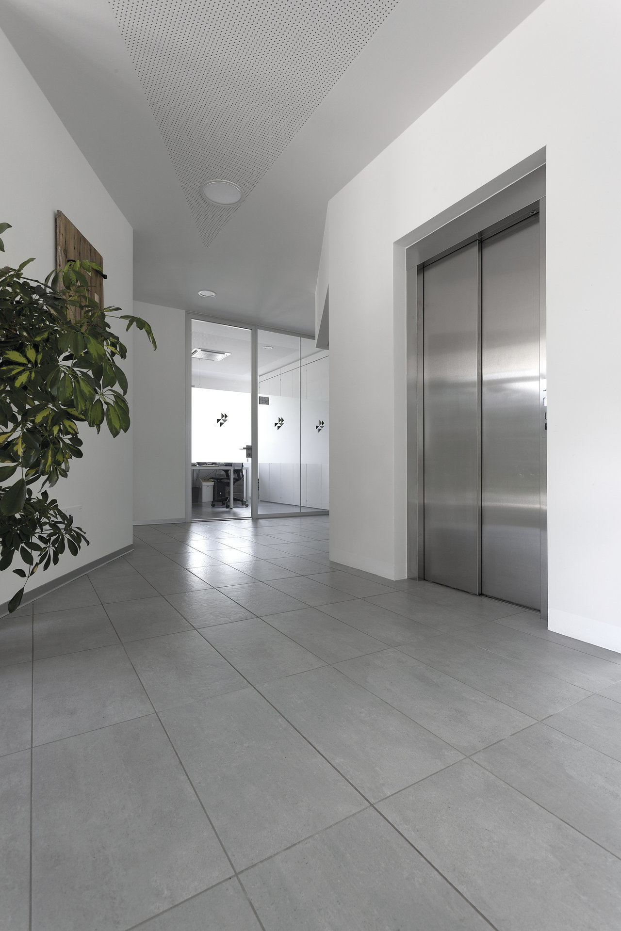 High-quality, large-format grey tiles in a modern hallway.