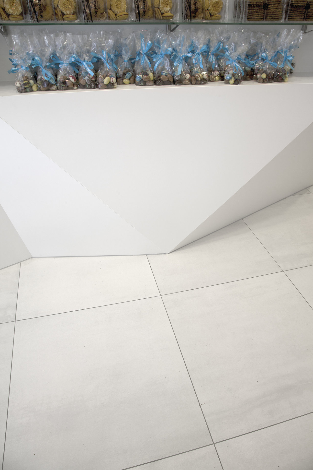 Modern, bright floor tiles with dark grout for an elegant room design.