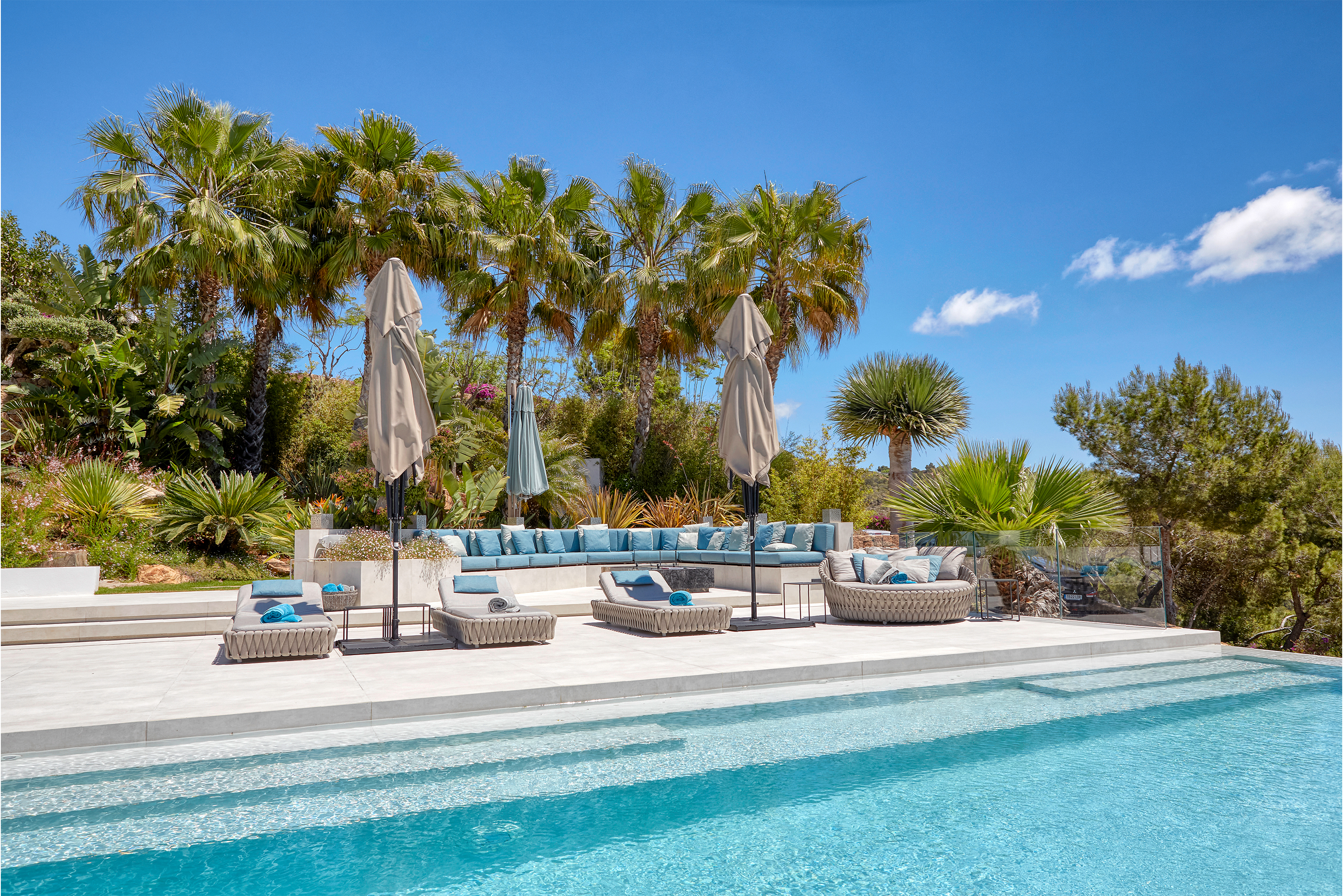Premium outdoor tiles on a luxurious pool terrace with lounge area.