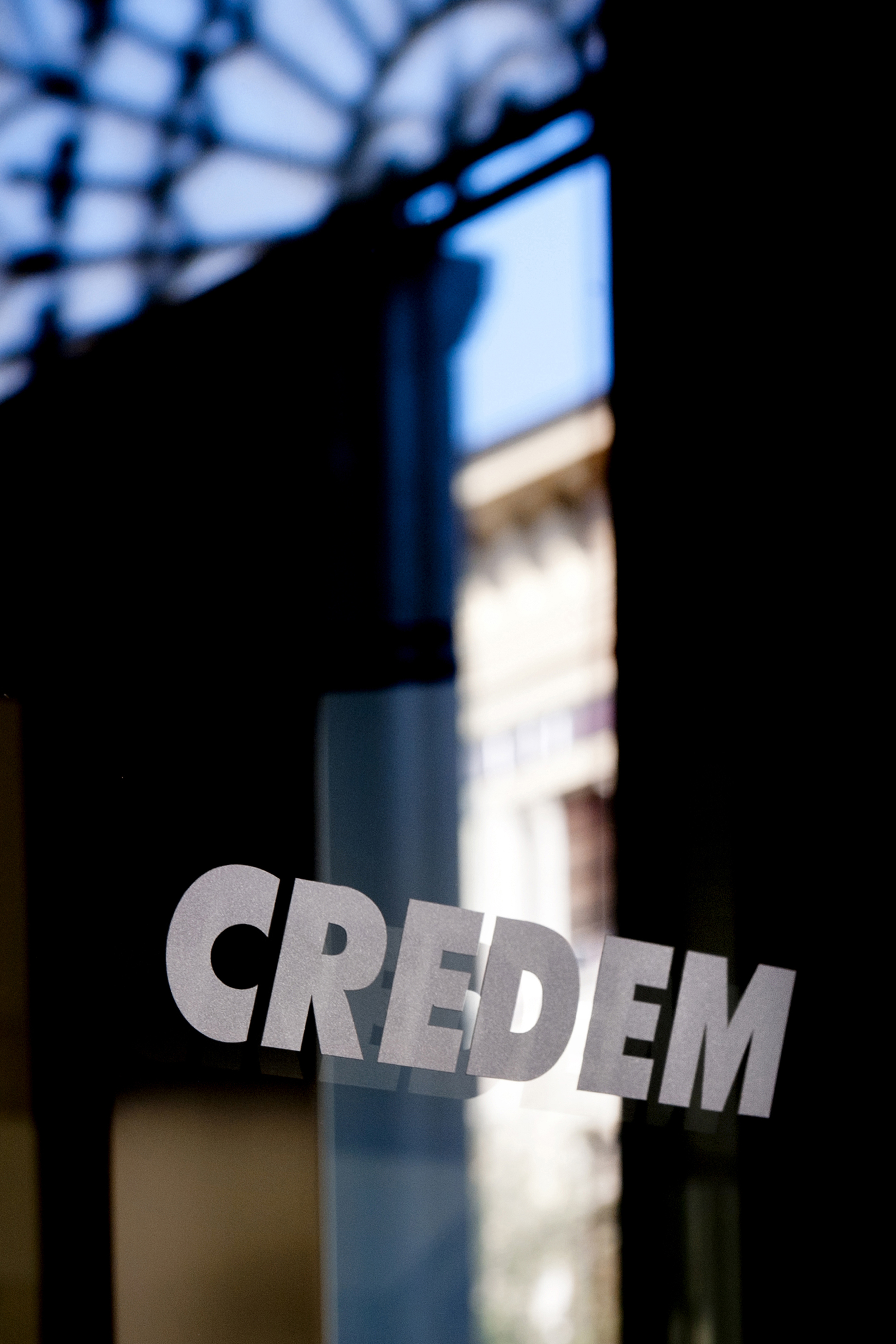 The word CREDEM on a dark glass panel.
