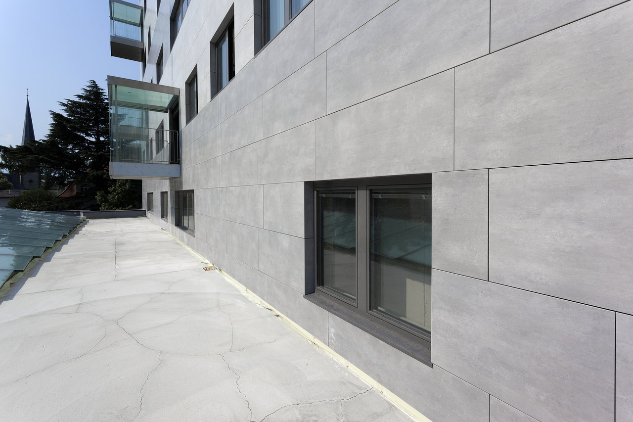 Modern grey facade and outdoor tiles.