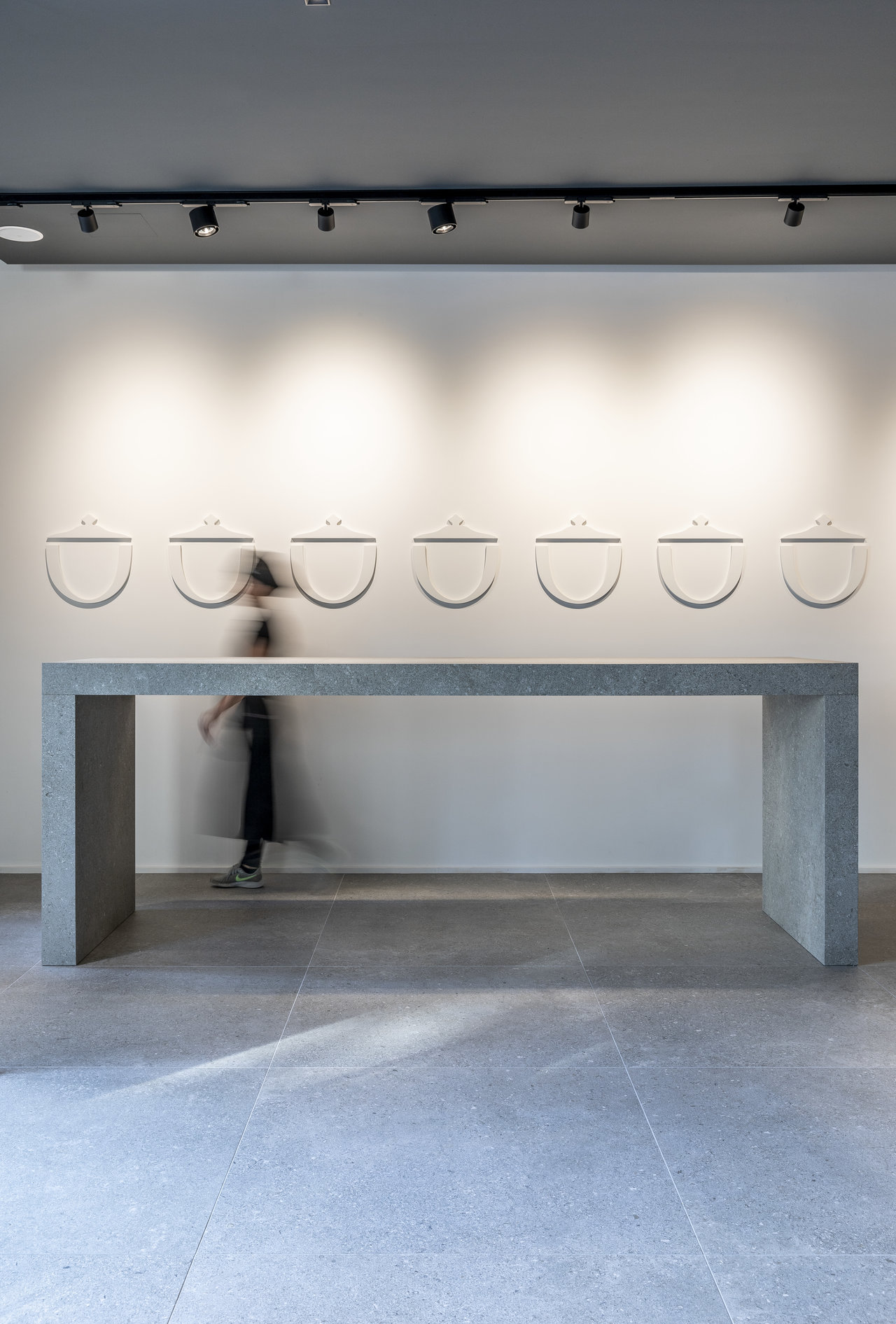Premium light grey floor tiles in a modern showroom.