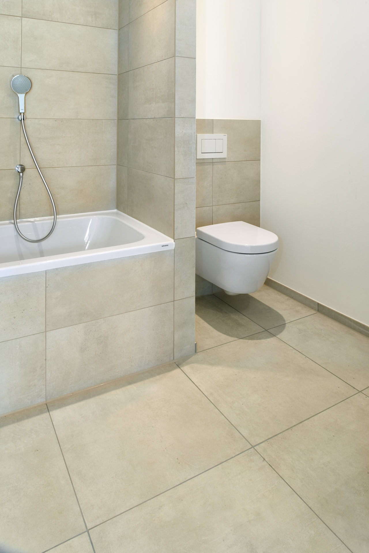 Modern bathroom with light beige Porcelaingres tiles for floor and walls.