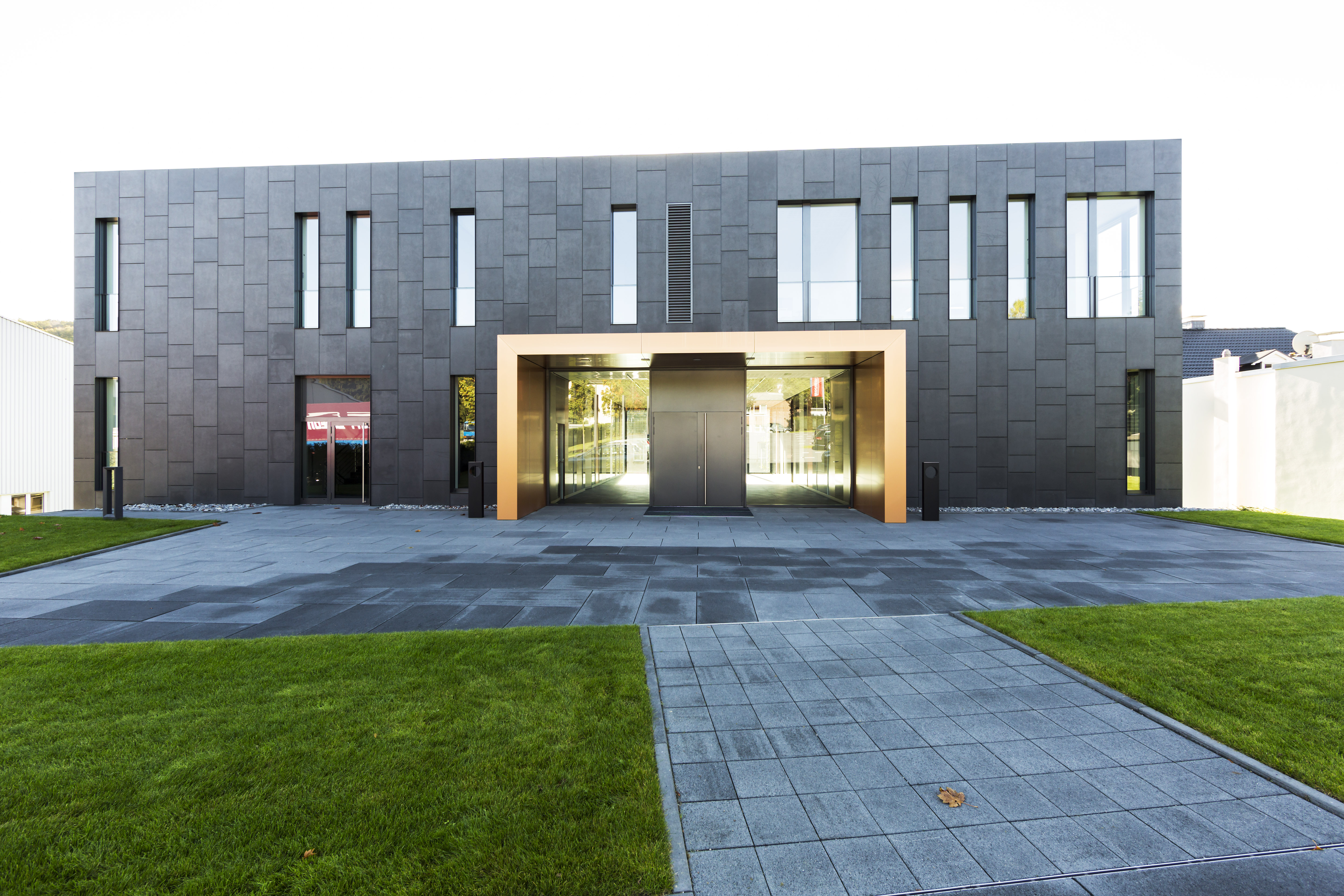 Impressive building with high-quality tile cladding and stylish outdoor paving.