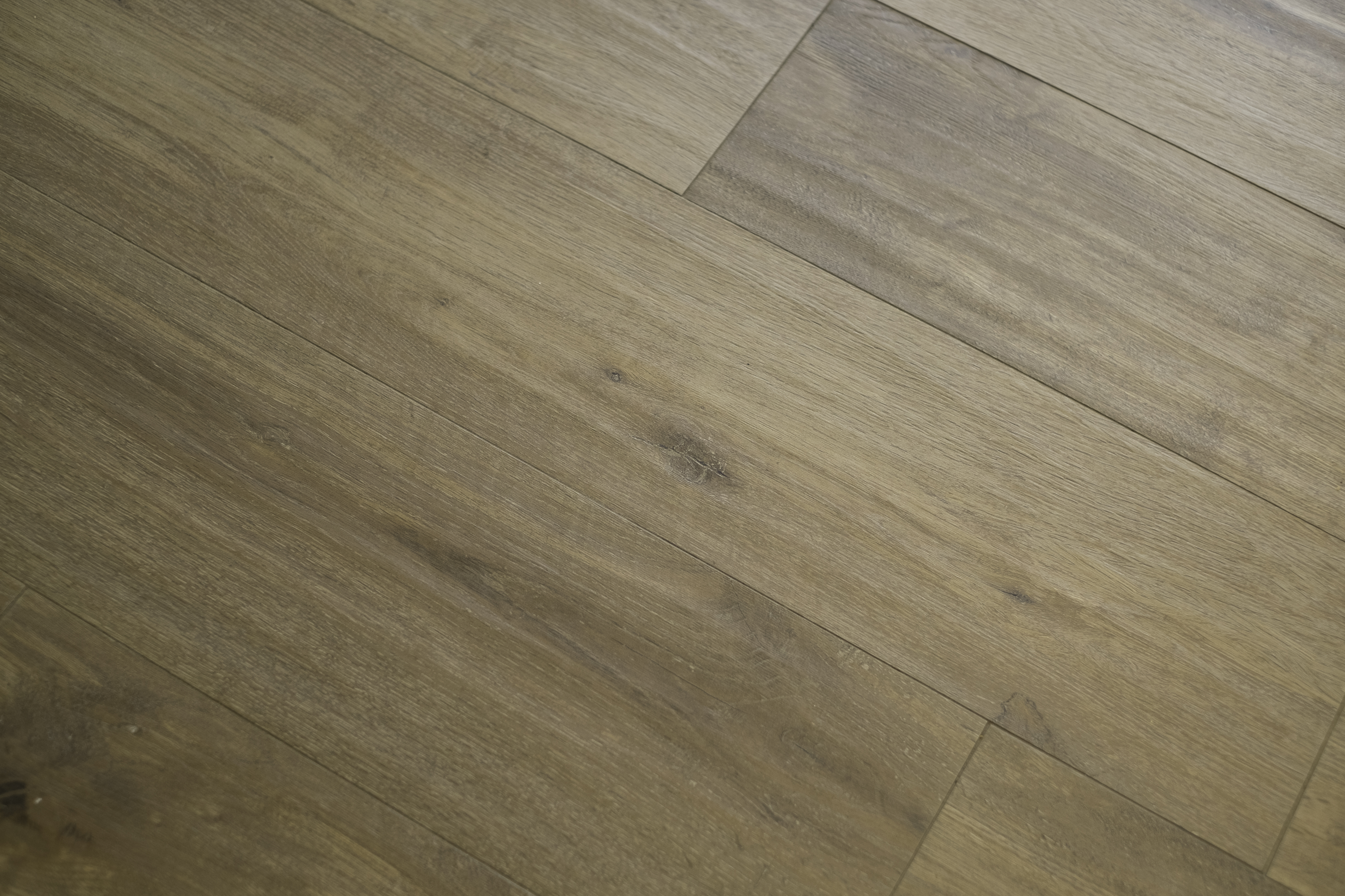 Light wood-look tiles with natural grain and knots, laid diagonally.