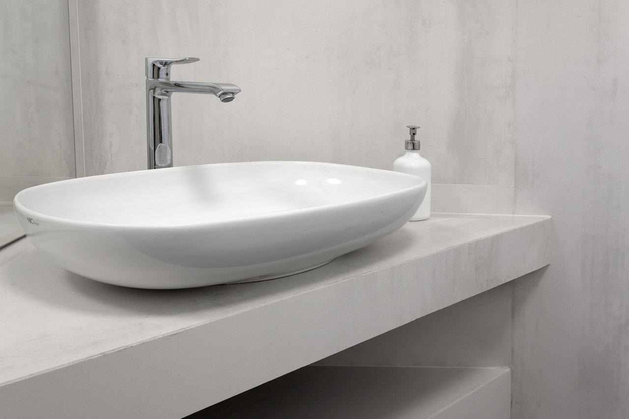 Light concrete-effect bathroom tiles with a stylish vanity.