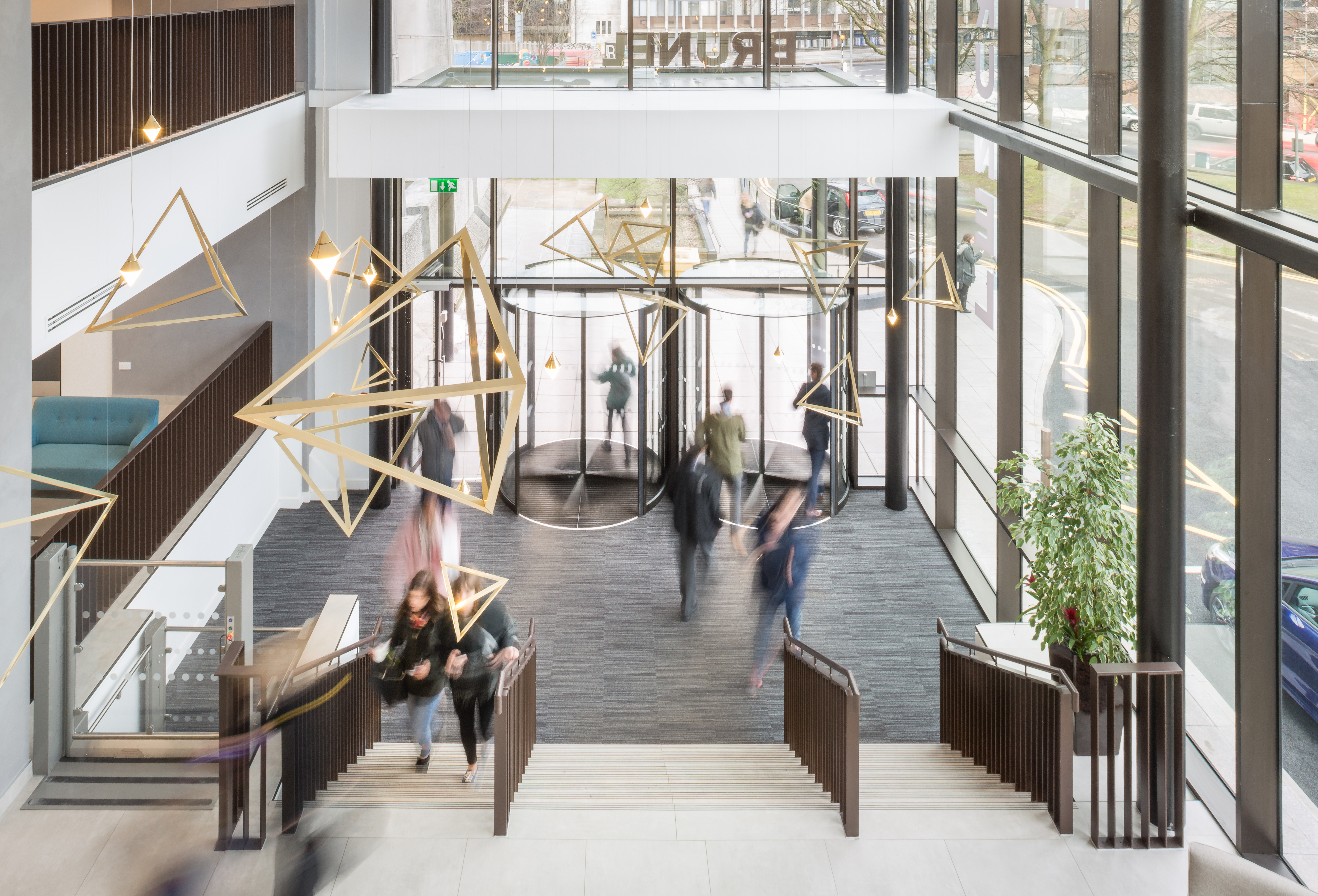 Modern Foyer with high-quality floor tiles and geometric lights.