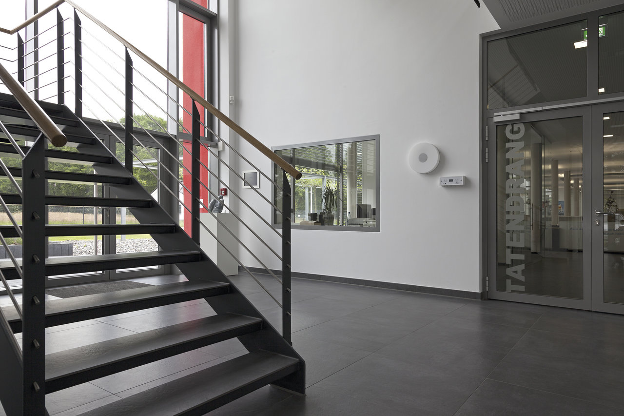 Dark, large-format tiles in a modern staircase.