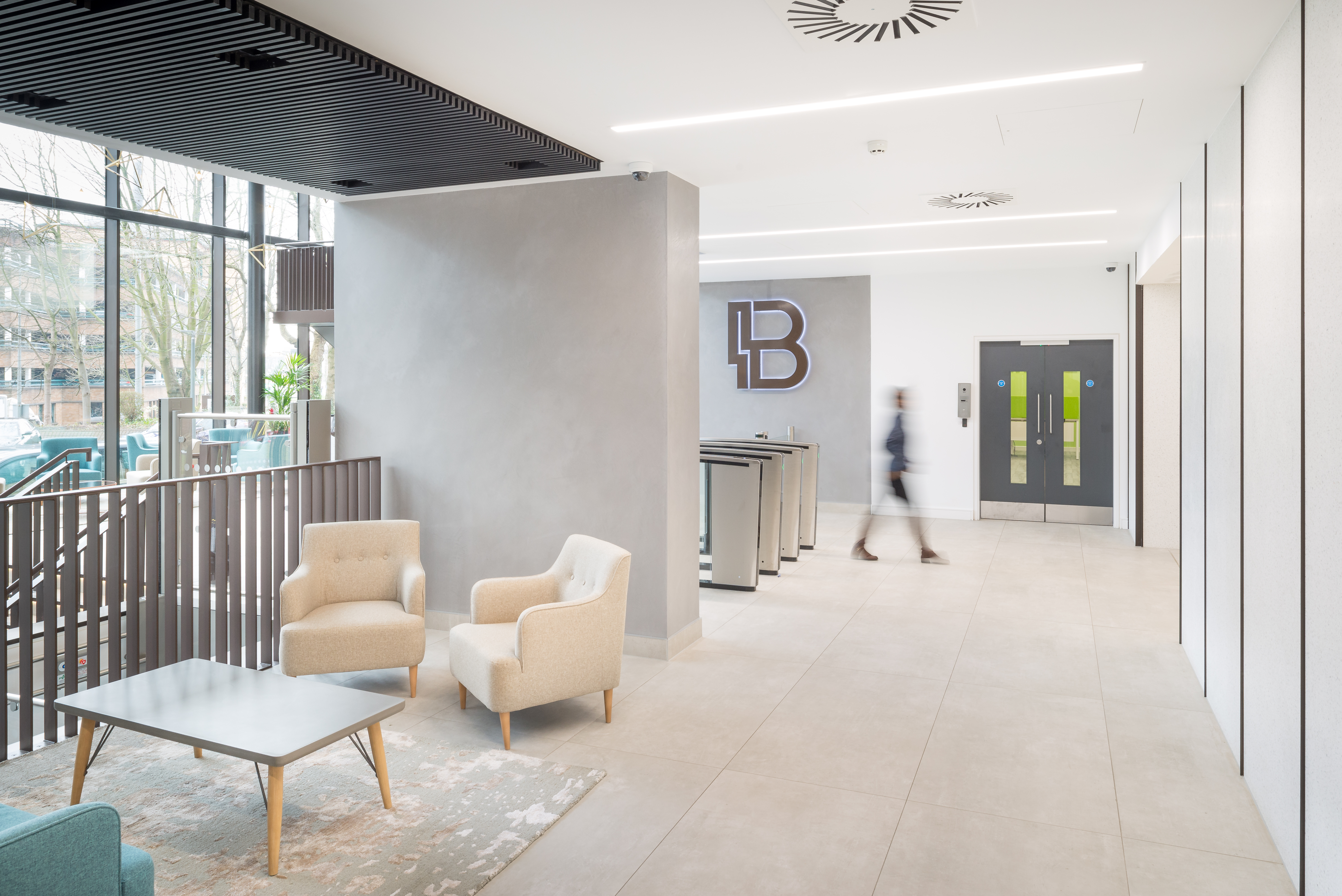 Modern, bright reception area with large-format floor tiles and seating.