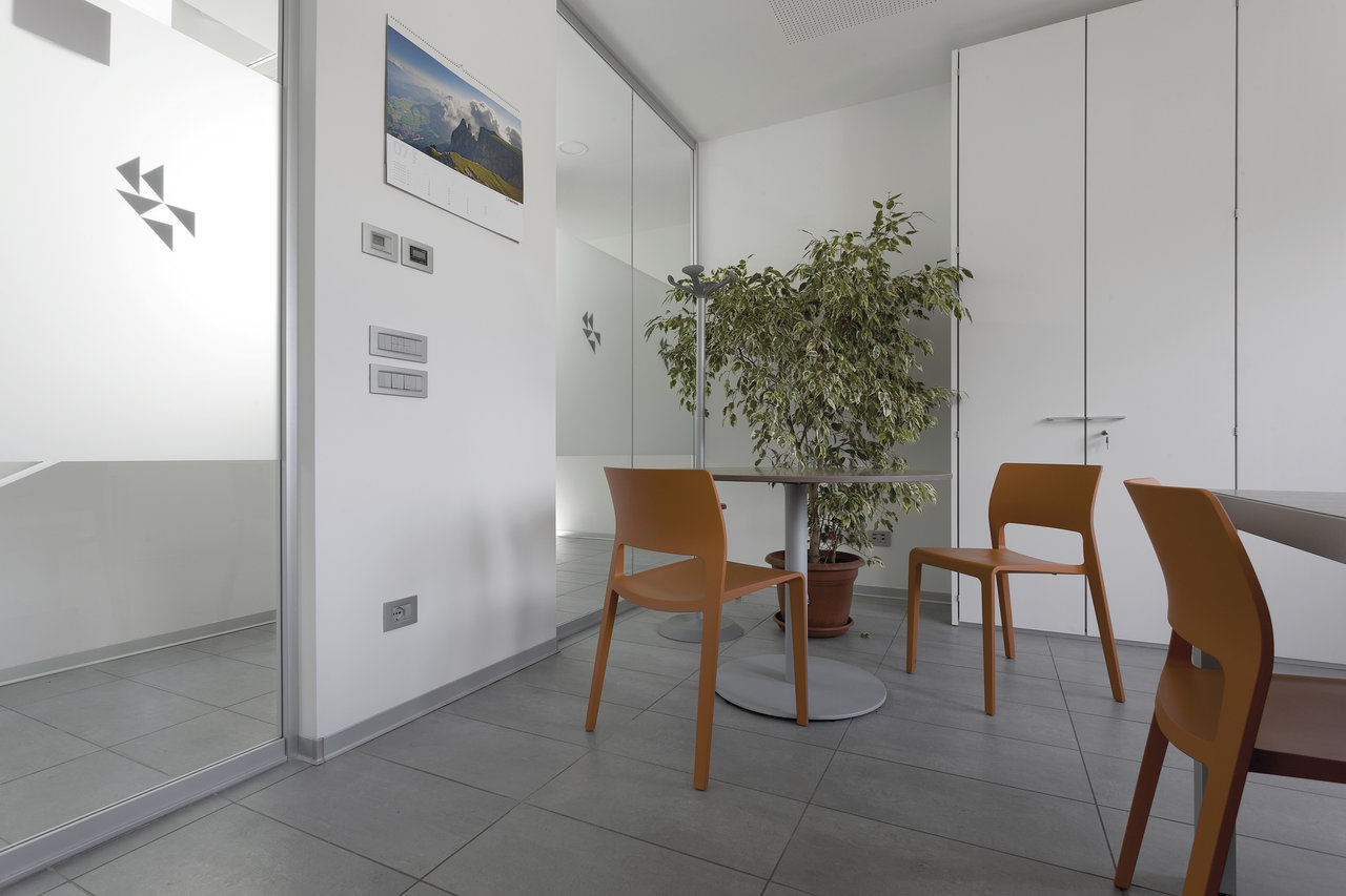 Robust grey floor tiles in a bright, modern interior.