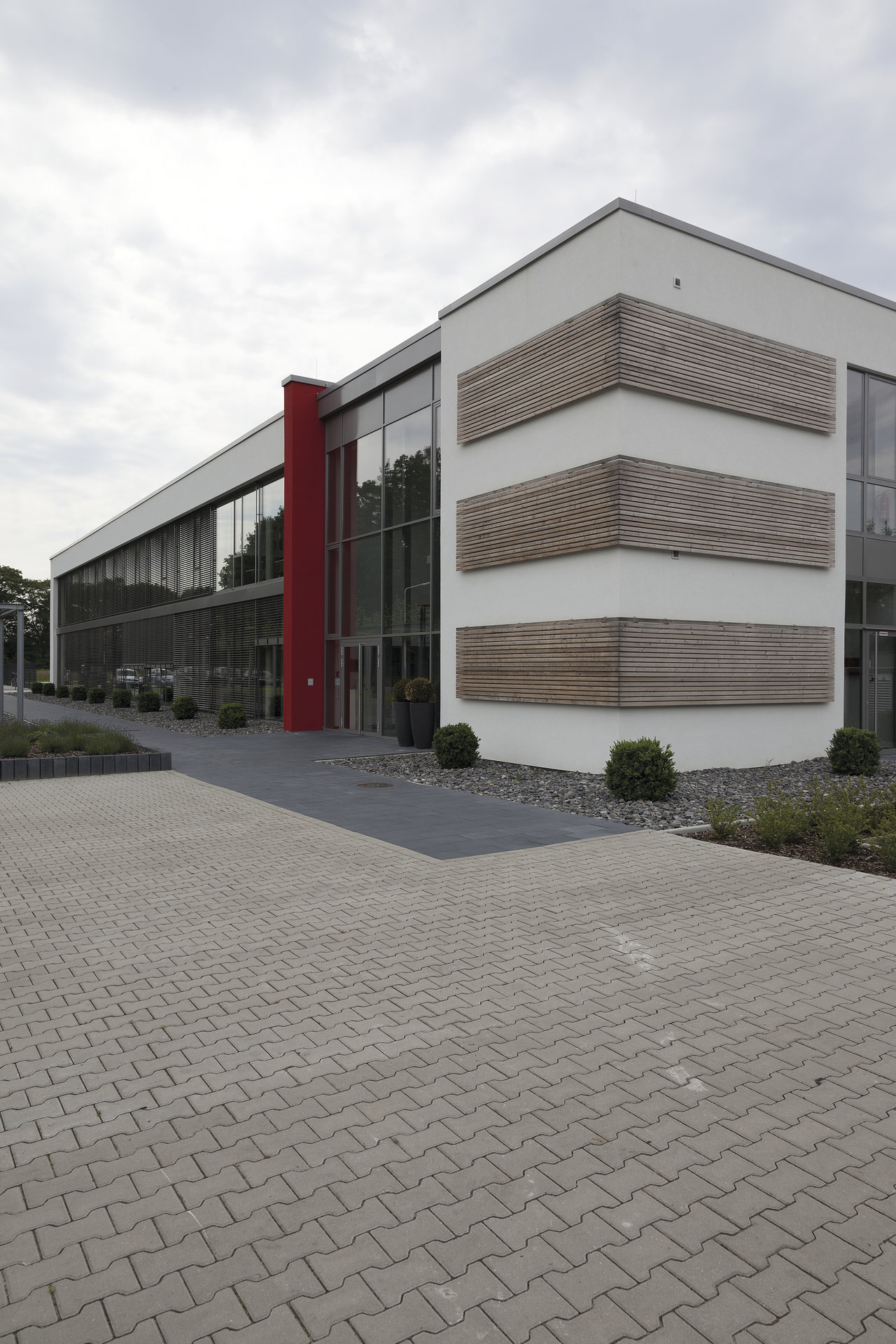 Modern building with paved forecourt of high-quality outdoor tiles.