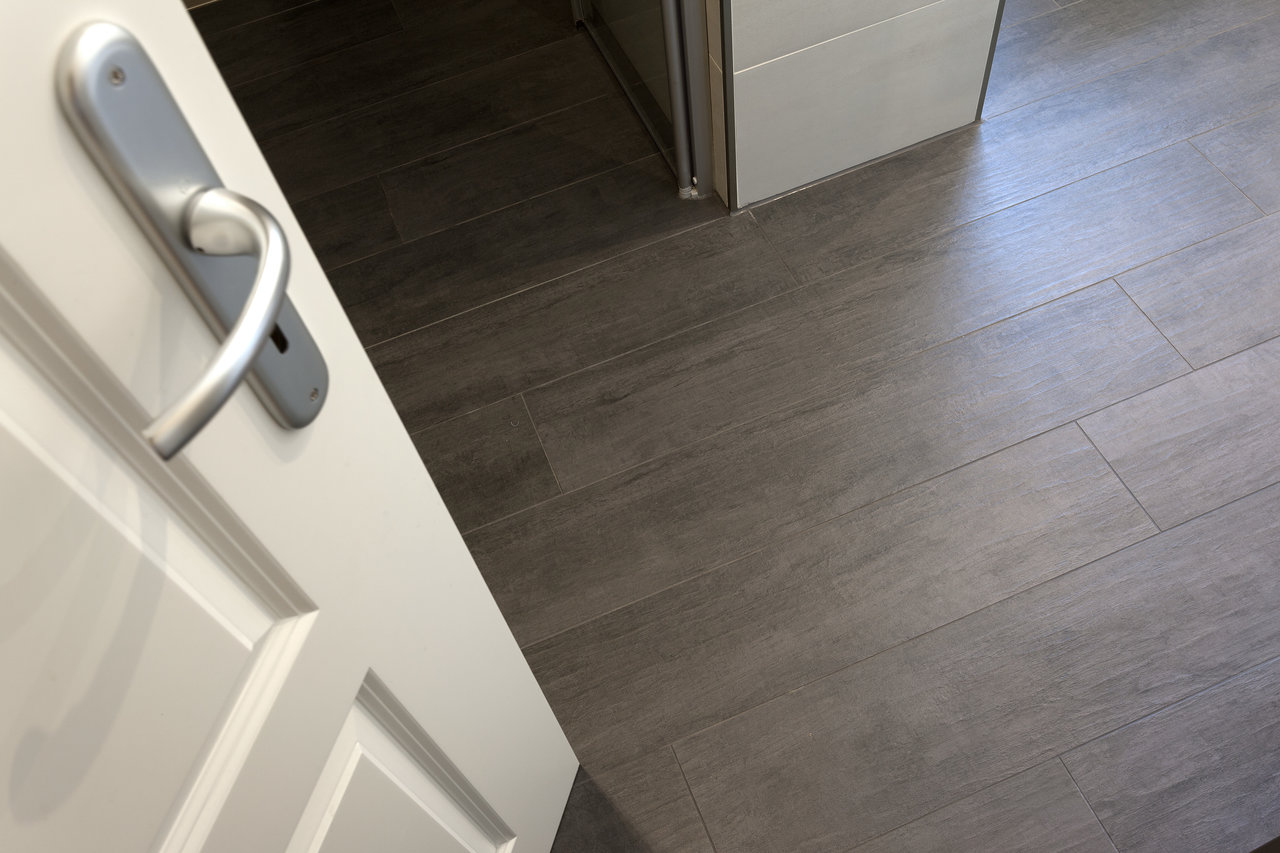 Dark grey, high-quality indoor tiles with an elegant wood or concrete look.