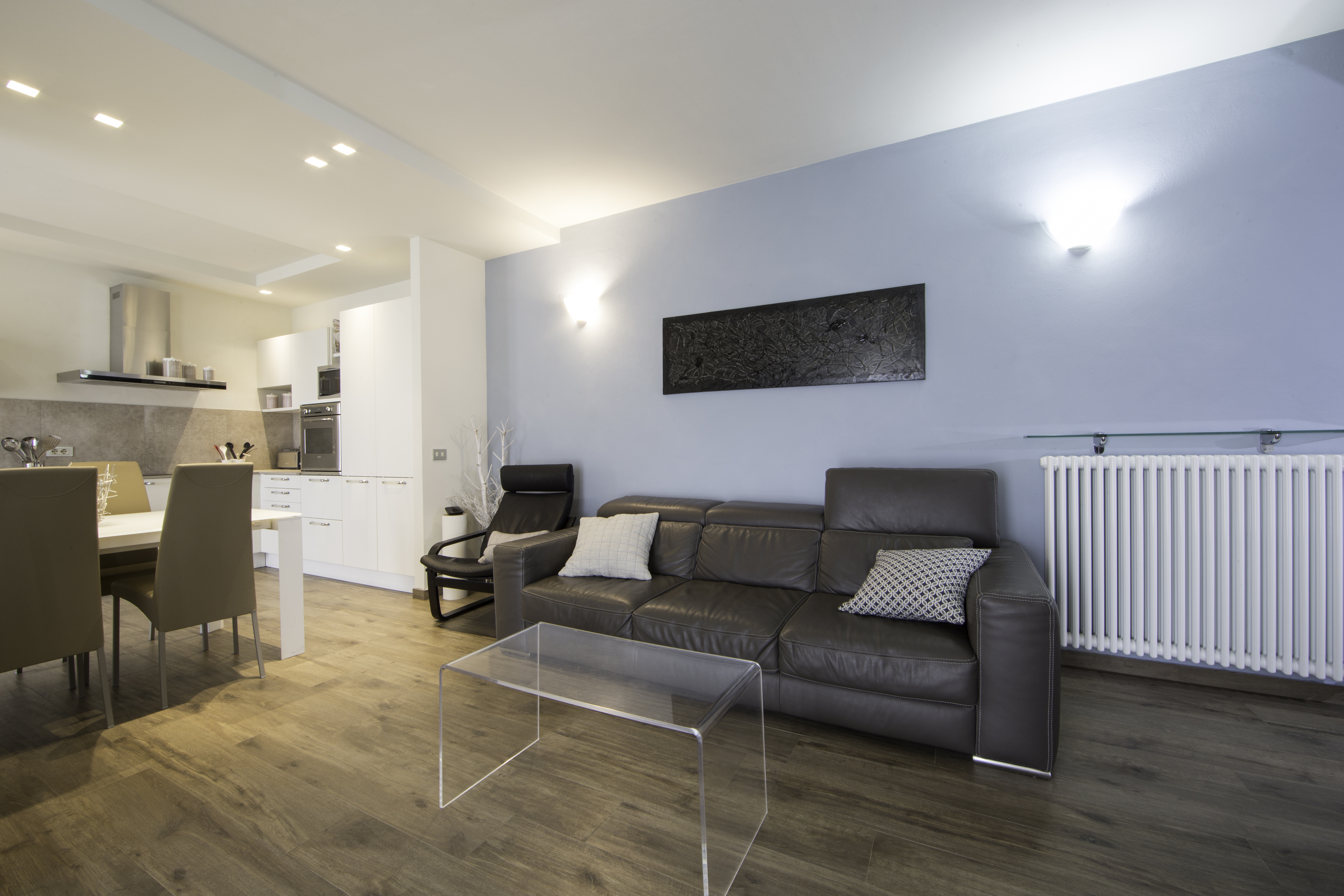 Modern living space with premium wood-effect tiles and dining area.