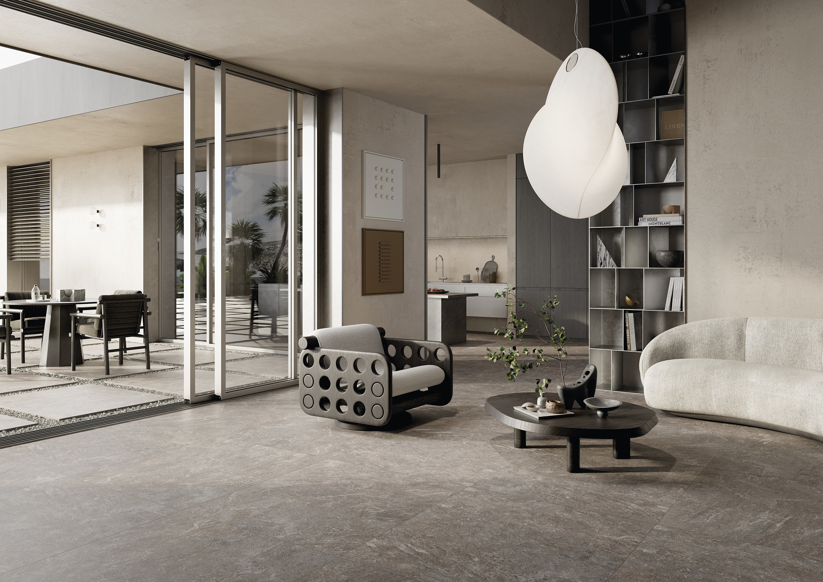 Large-format grey tiles in a luxurious living room with patio doors.