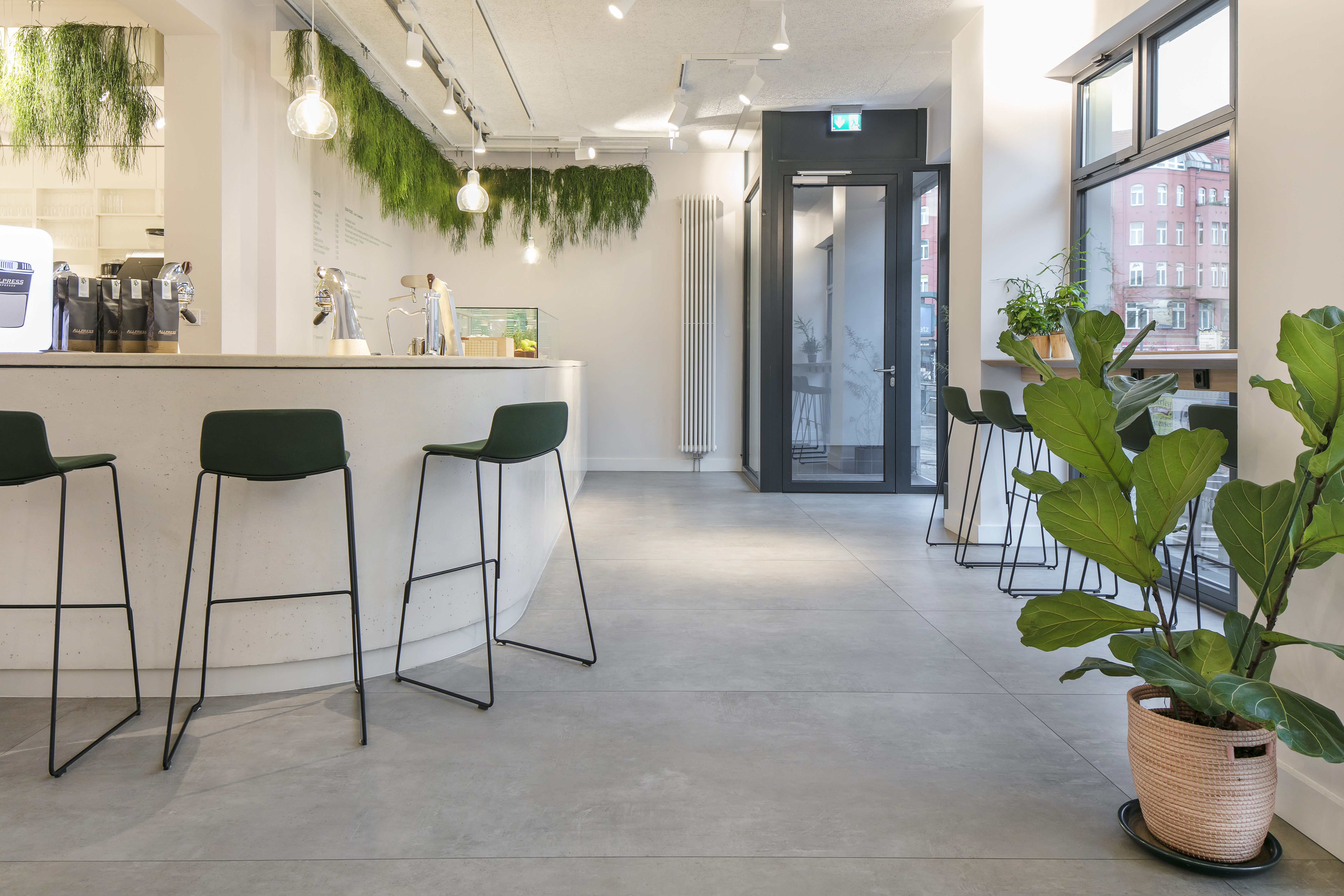 Bright, modern interior with large-format concrete-effect floor tiles.
