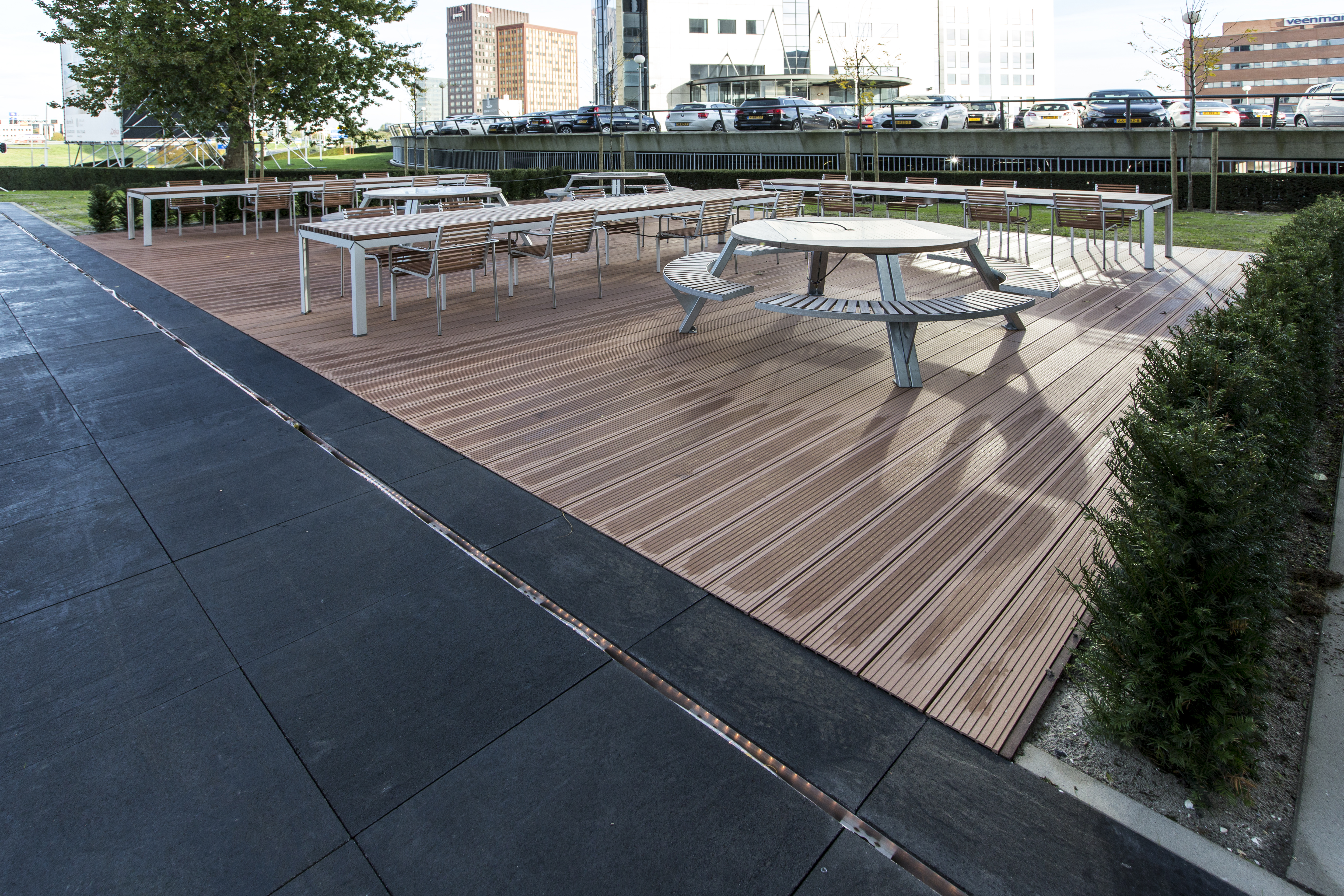 Outdoor tiles in anthracite and wood look on a modern terrace with seating.