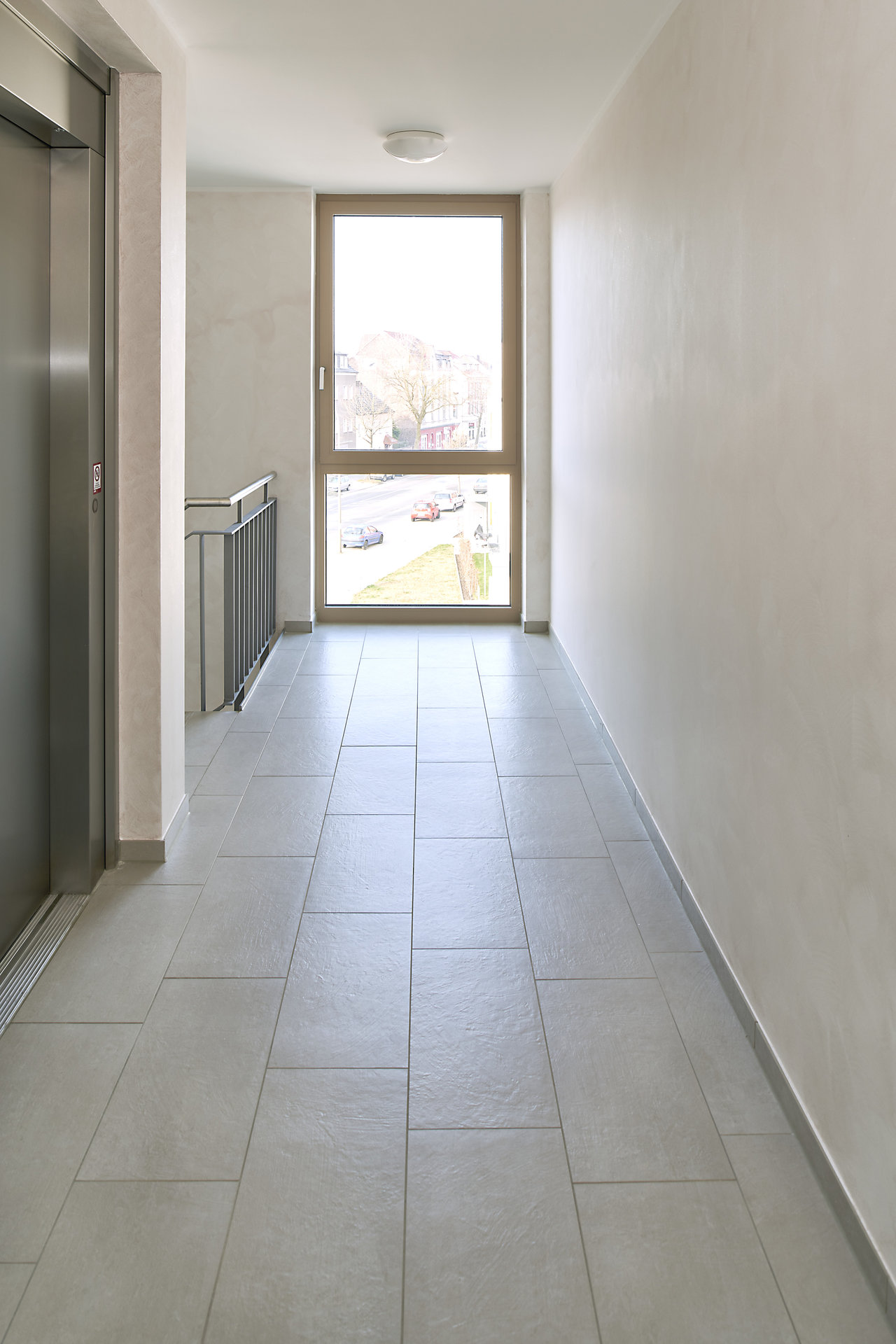 Light, modern grey hallway tiles, perfect for indoors.