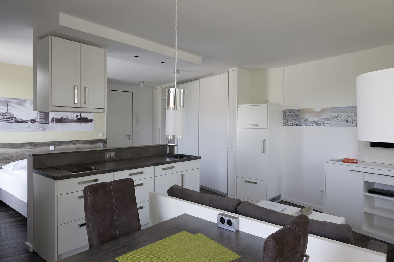 Stylish apartment with dark tiled floor, ideal for high-quality Porcelaingres tiles.