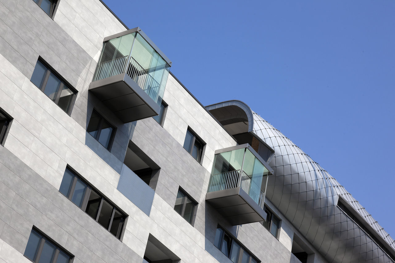 Architecture with high-quality grey facade tiles and elegant glass balconies.