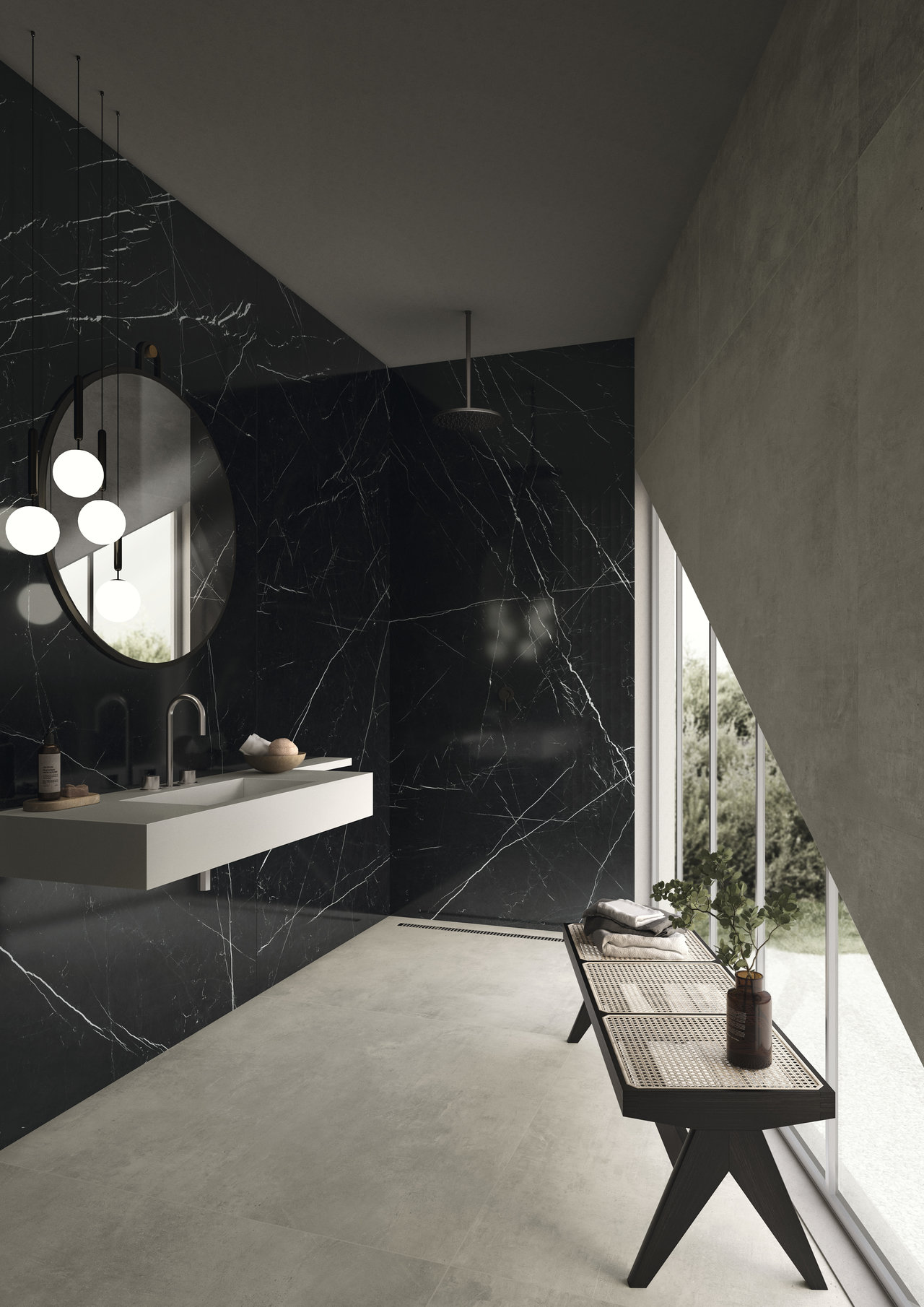 Modern bathroom with black marble-effect wall tiles and light floor tiles.